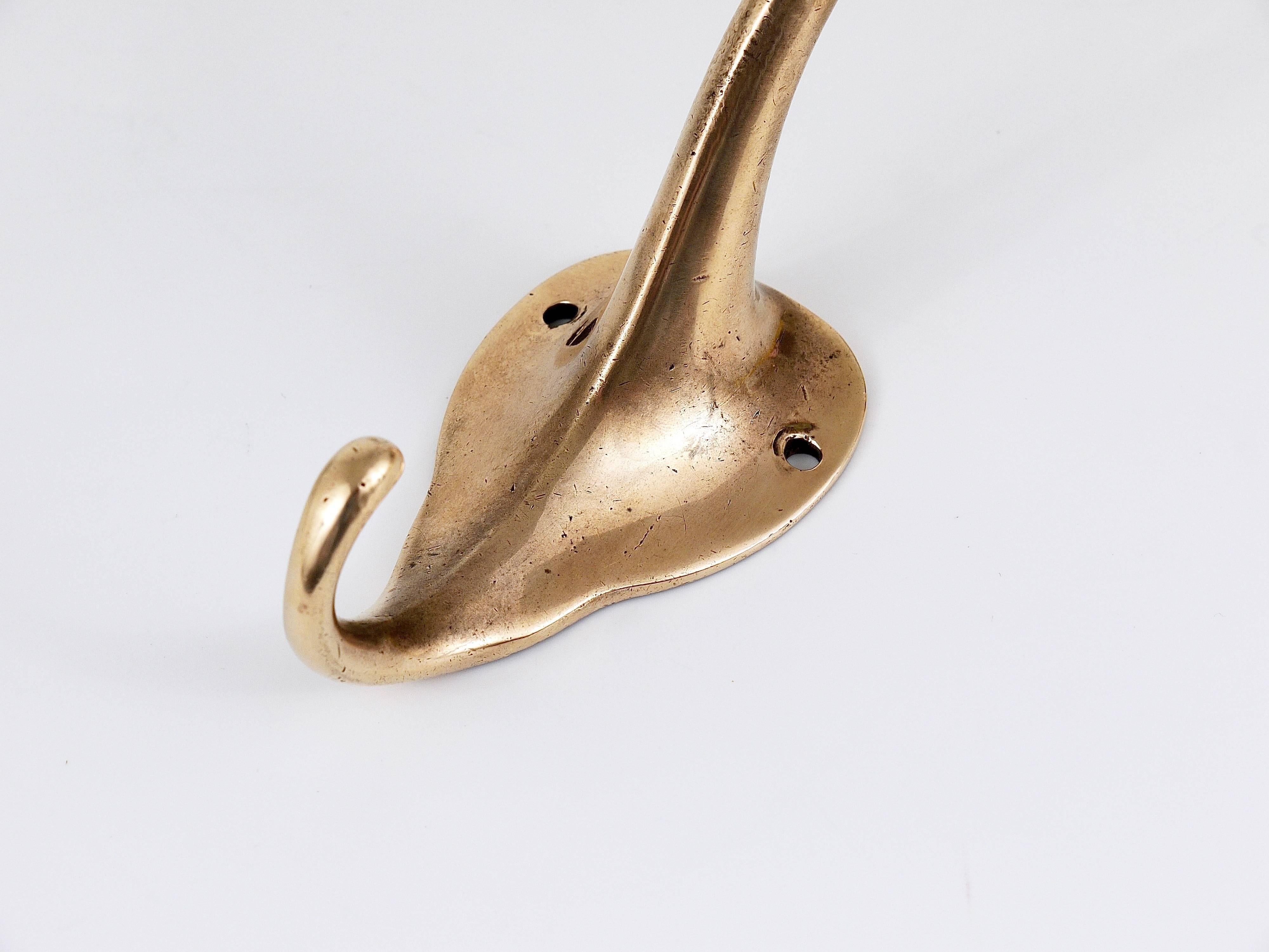 A beautiful Art Nouveau brass wall coat hook designed by Adolf Loos, executed by Werkstätte Hagenauer, Vienna, 1910. In good condition with charming patina.