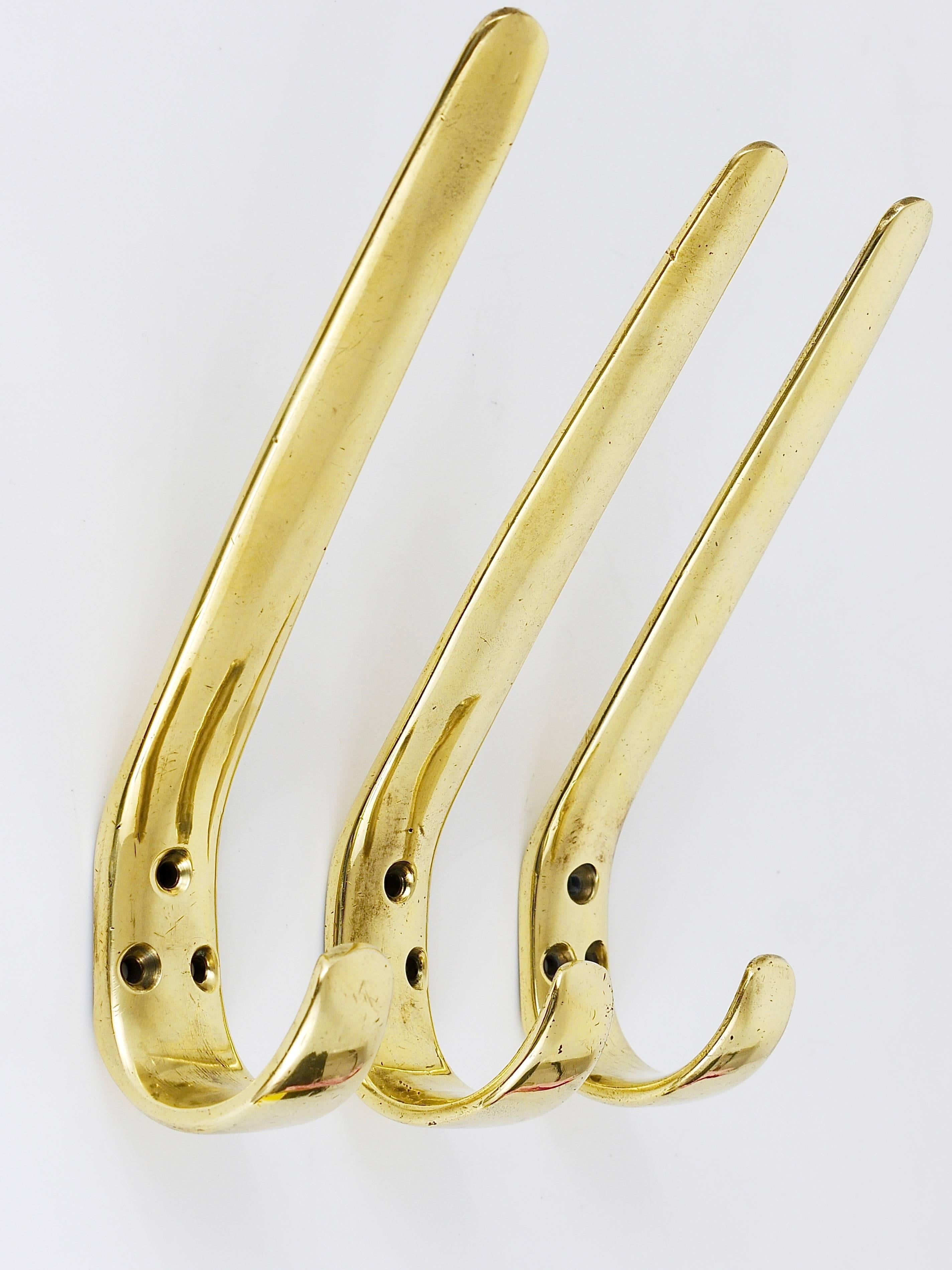 Three beautiful modernist brass wall hooks, manufactured in the 1950s by Hertha Baller, Austria. Gently polished by hand, in excellent condition with nice patina. The price is for the set of three hooks.