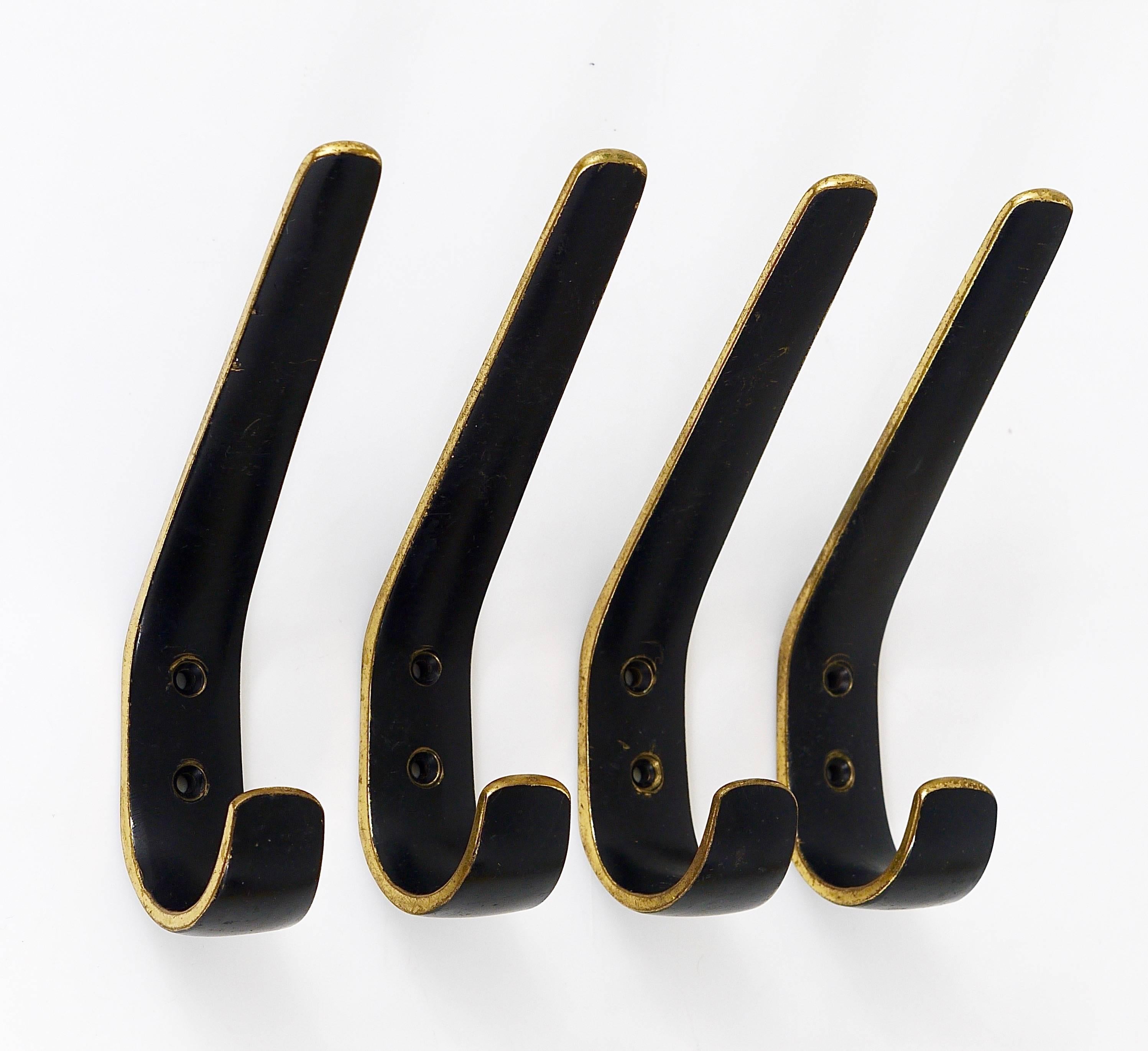 A set of four beautiful Austrian modernist wall hooks, made of black-finished brass, executed in the 1950s by Hertha Baller, Austria. In good condition, with nice patina. The price is for the set of four hooks.