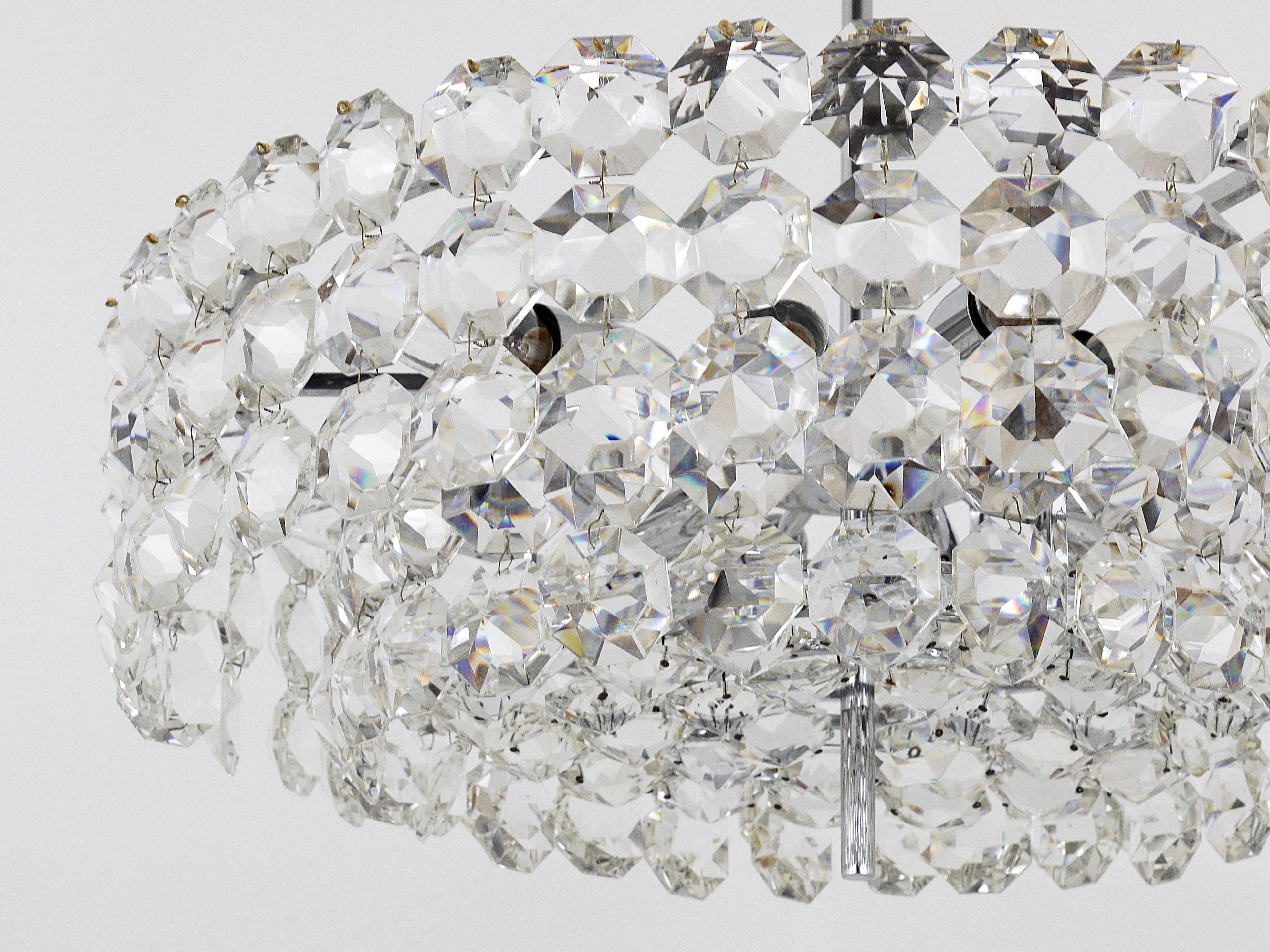 A beautiful, large brass crystal chandelier from the 1950s, manufactured by Bakalowits & Sohne, Vienna. Nickel-plated hardware, it has two tiers, fully covered by big, octagonal diamond-shaped faceted crystals. This chandelier has twelve-light