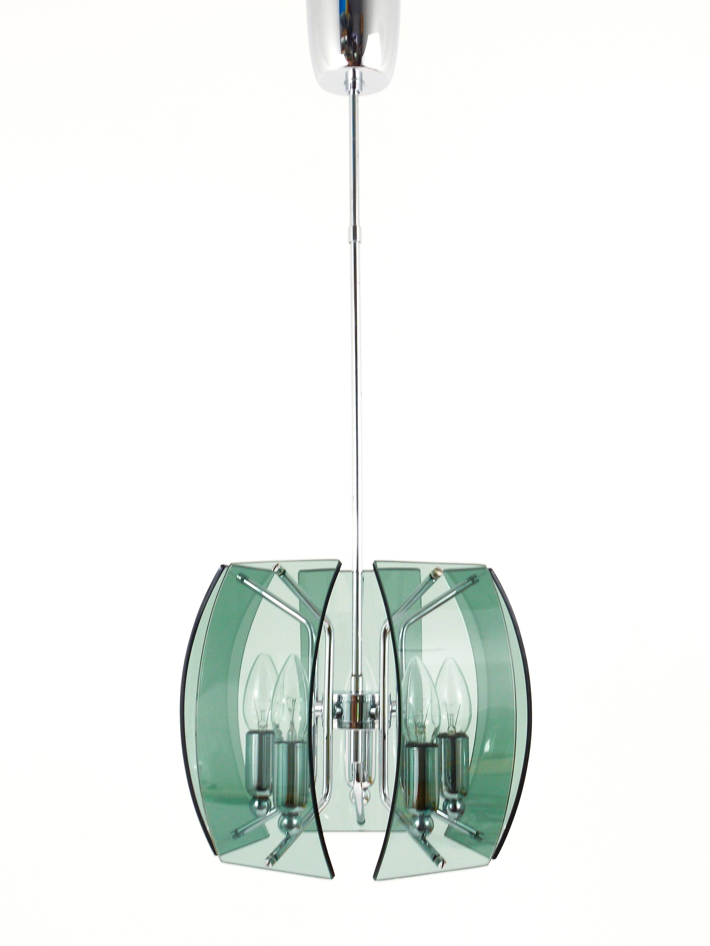 A beautiful Italian modernist glass pendant lamp from the 1960s. Five green/grey and curved glass panels on a chrome-plated five-arm frame. In very good condition. Height of stem can be adjusted upon request as a free service. 

Measurements: