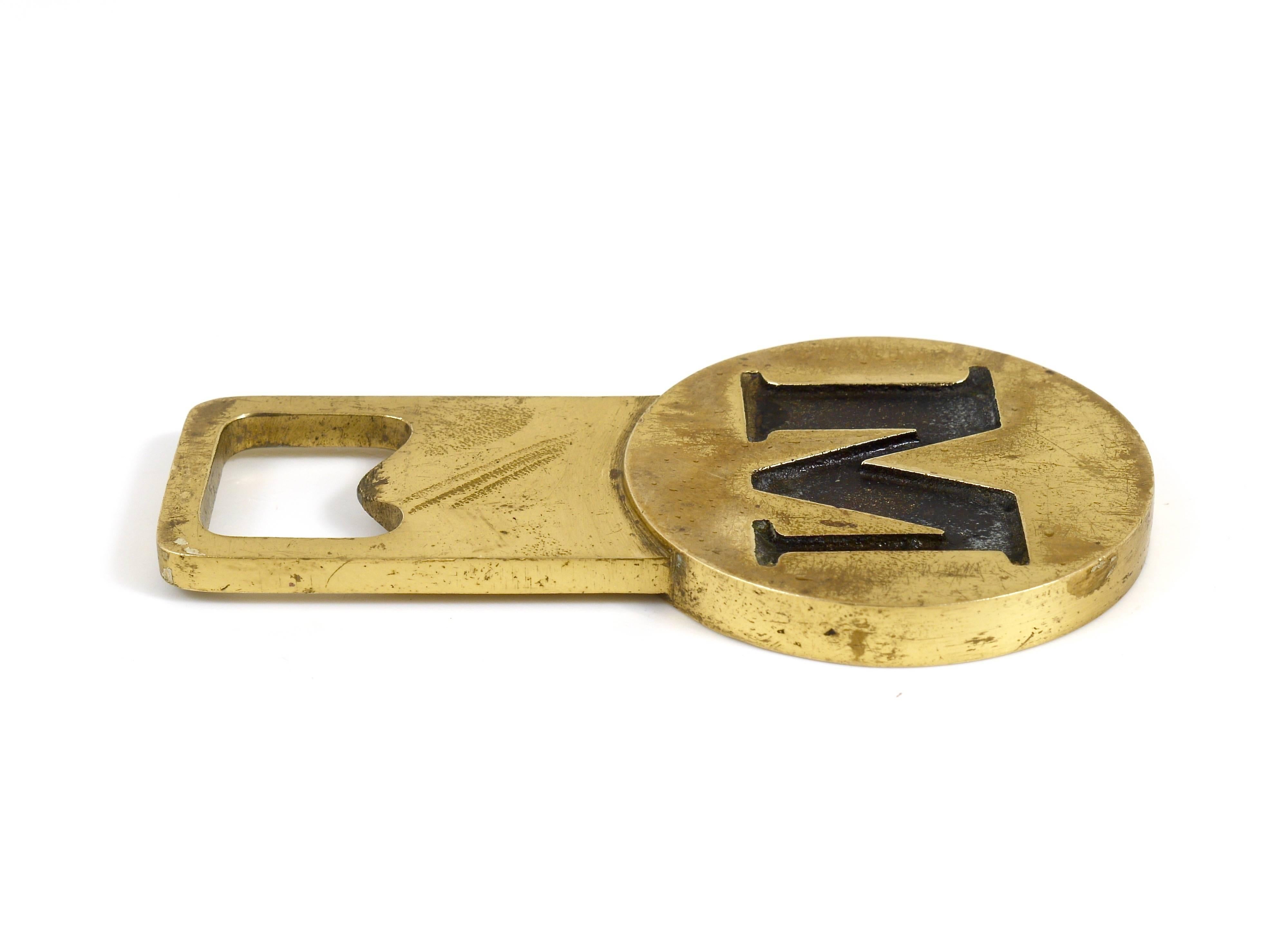 A beautiful modernist bottle opener, displaying the letter 