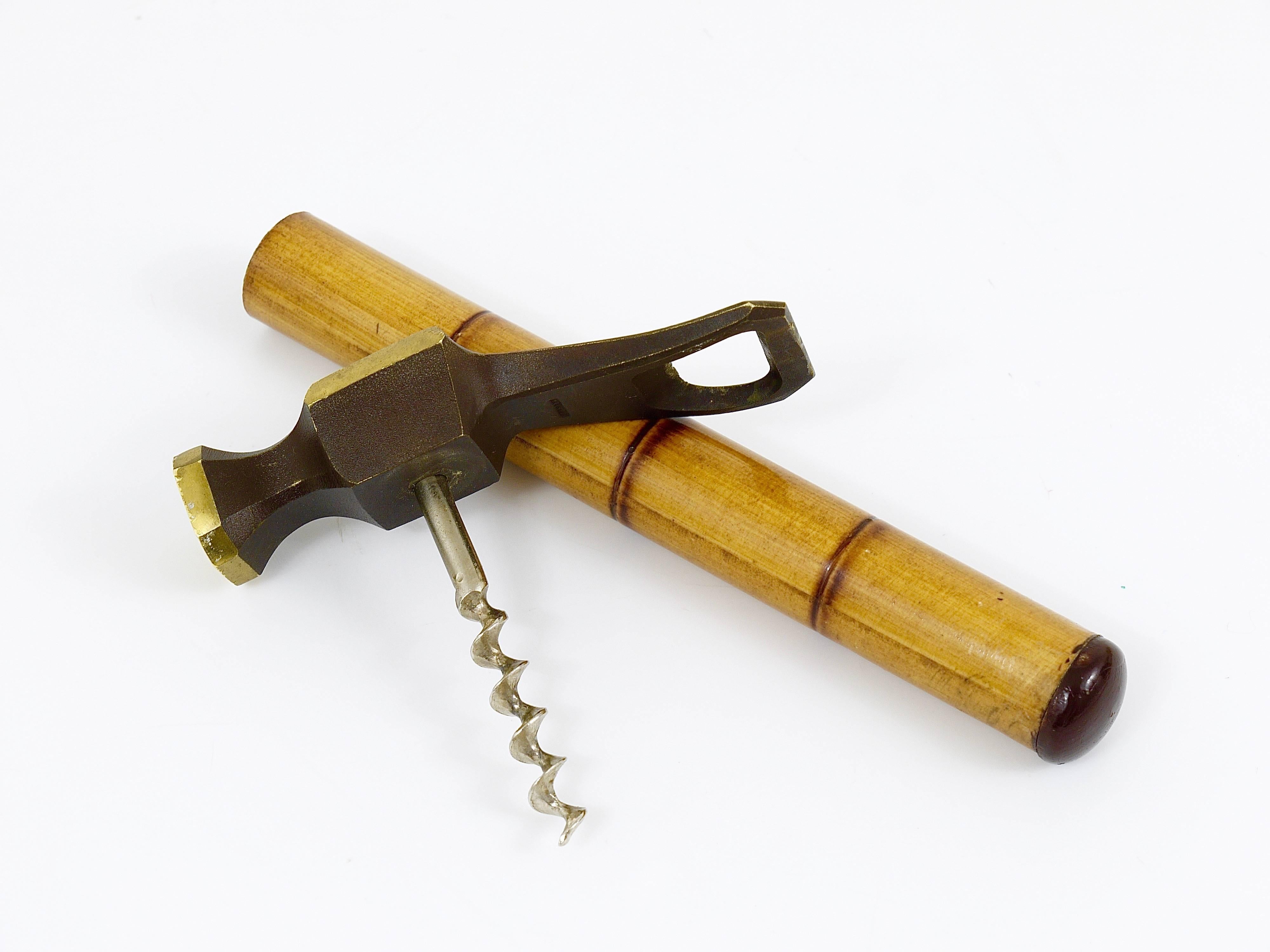 An unusual modernist bottle opener in the shape of a Hammer. Made of brass with a nice bamboo handle. Made in Germany in the 1950s. In good condition. A very outstanding piece.