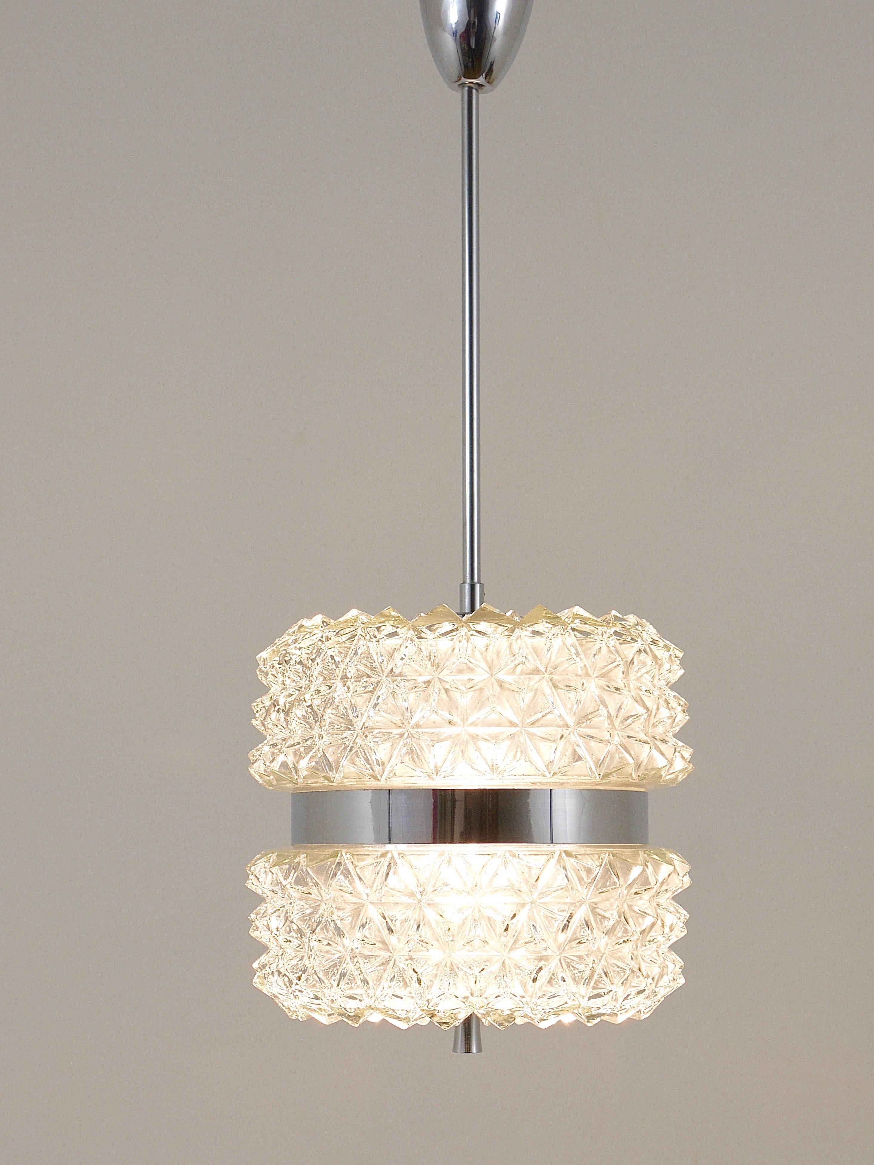A beautiful pendant lamp featuring a faceted glass lampshade and chrome-plated hardware, originating from the 1960s. This piece embodies the distinctive style reminiscent of Carl Fagerlund, renowned for his designs at Orrefors, Sweden. Remarkably