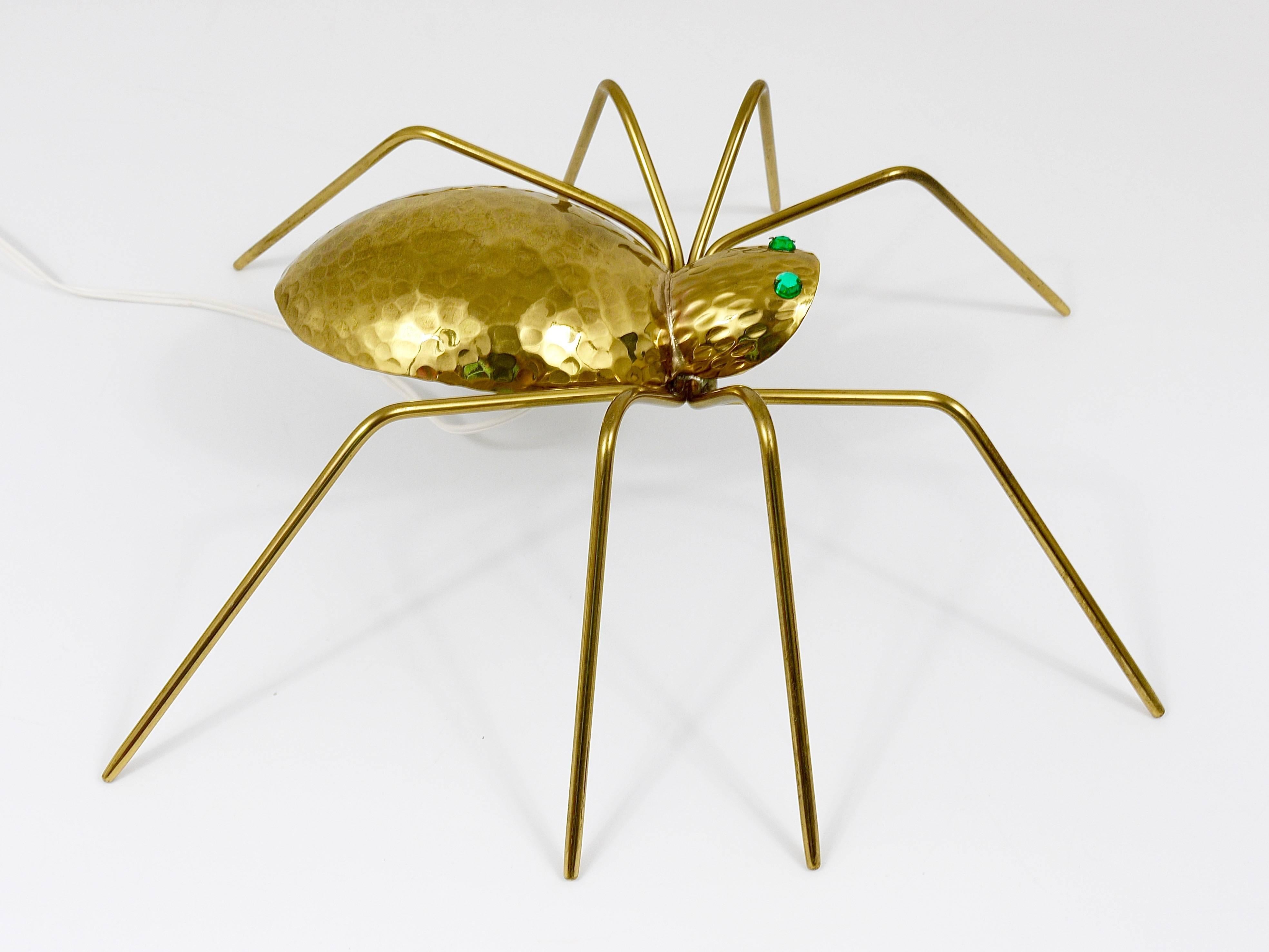 An exceptional handmade Mid-Century spider lamp, Austria, 1950s. To be used as a table lamp, side lamp or wall lamp or sconce. High-quality craftsmanship, made of Hammer-blown brass with faceted green crystal glass eyes. In excellent condition. A