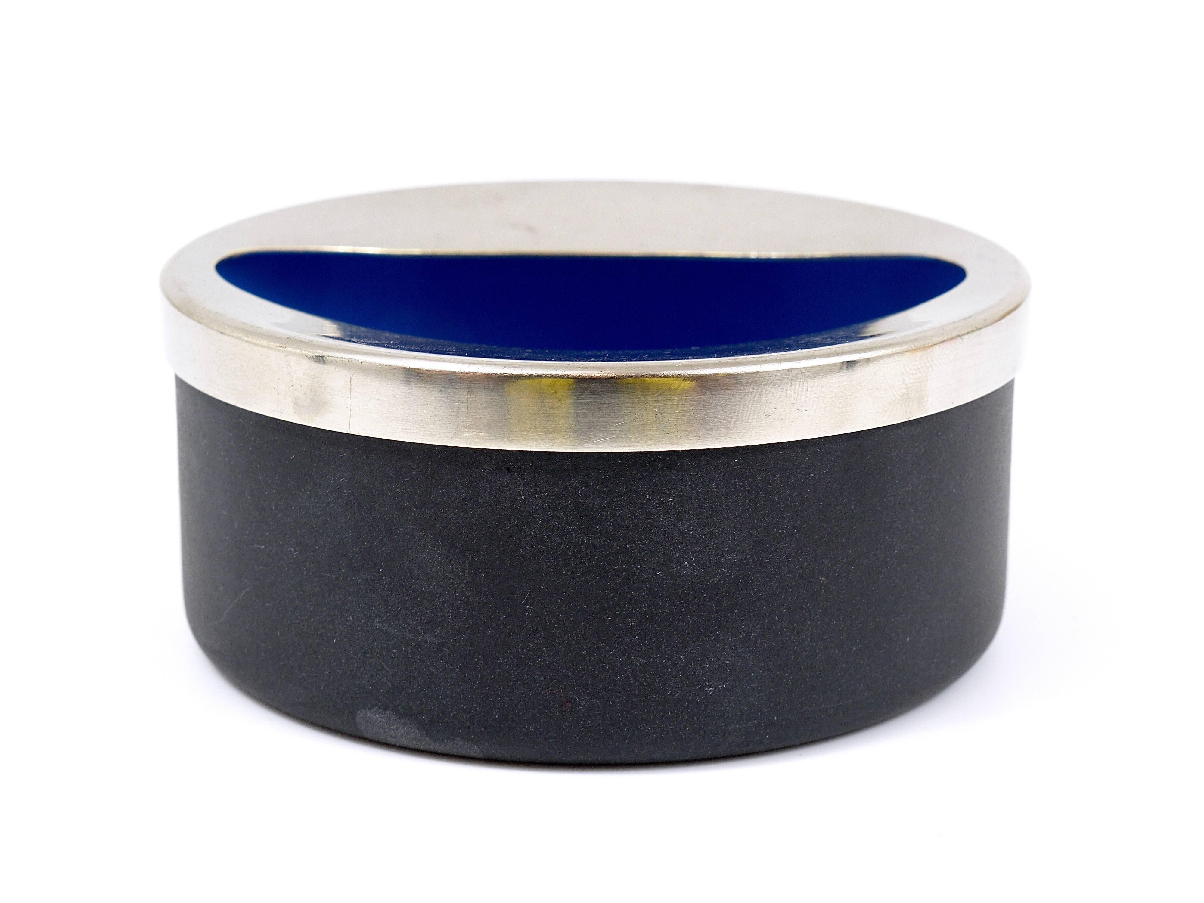 A beautiful modernist vintage ashtray made of enameled steel from the 1960s. Designed by Carl Aubock, Austria. matte black with a blue glossy interior and a stainless steel lid. In good condition with charming patina.