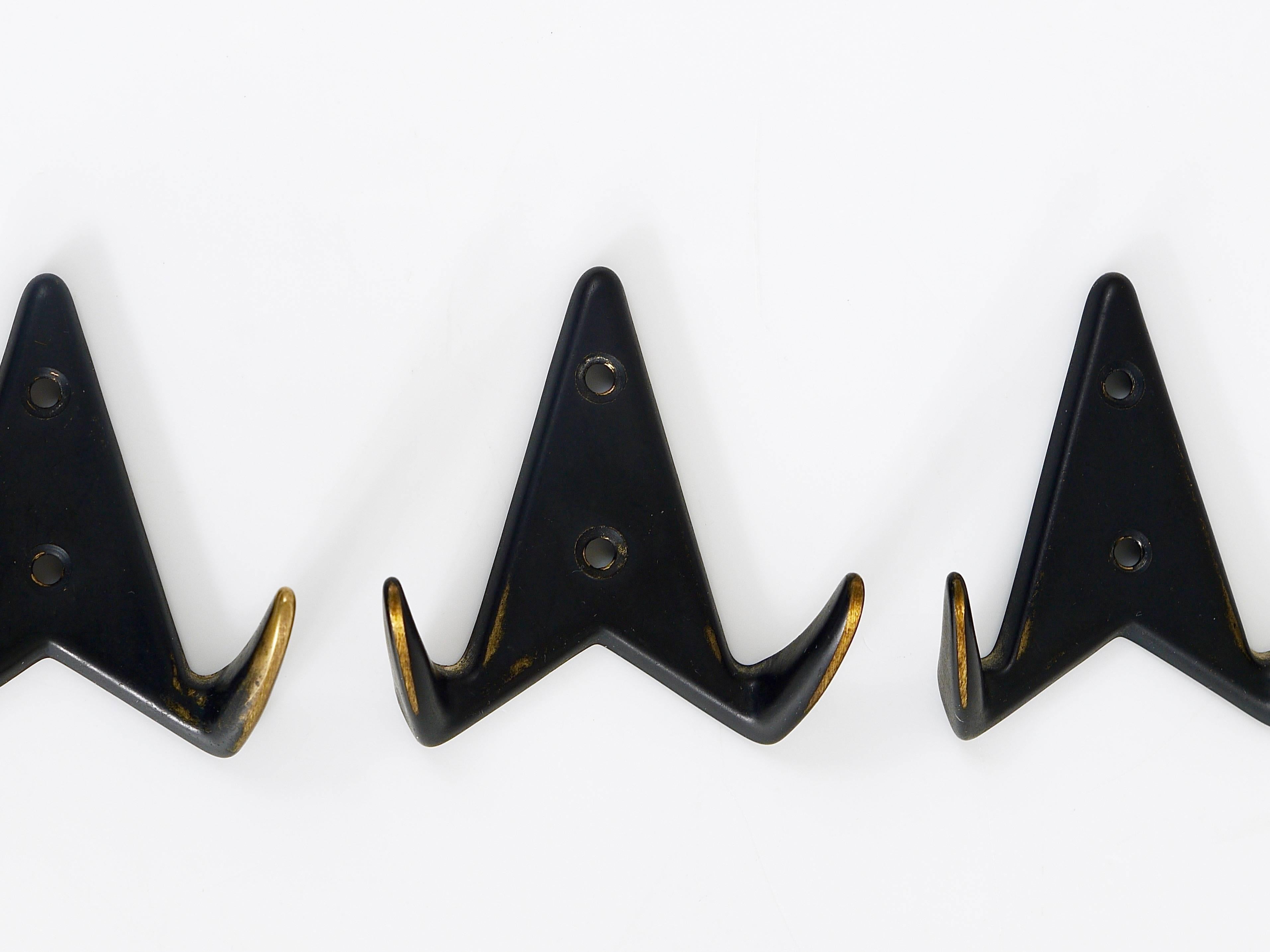 A set of three beautiful modernist wall hooks from the 1950s, made of black-finished brass. Made in Austria. To be used as coat hooks, but also for towels in the bathroom or in the kitchen. In excellent condition.