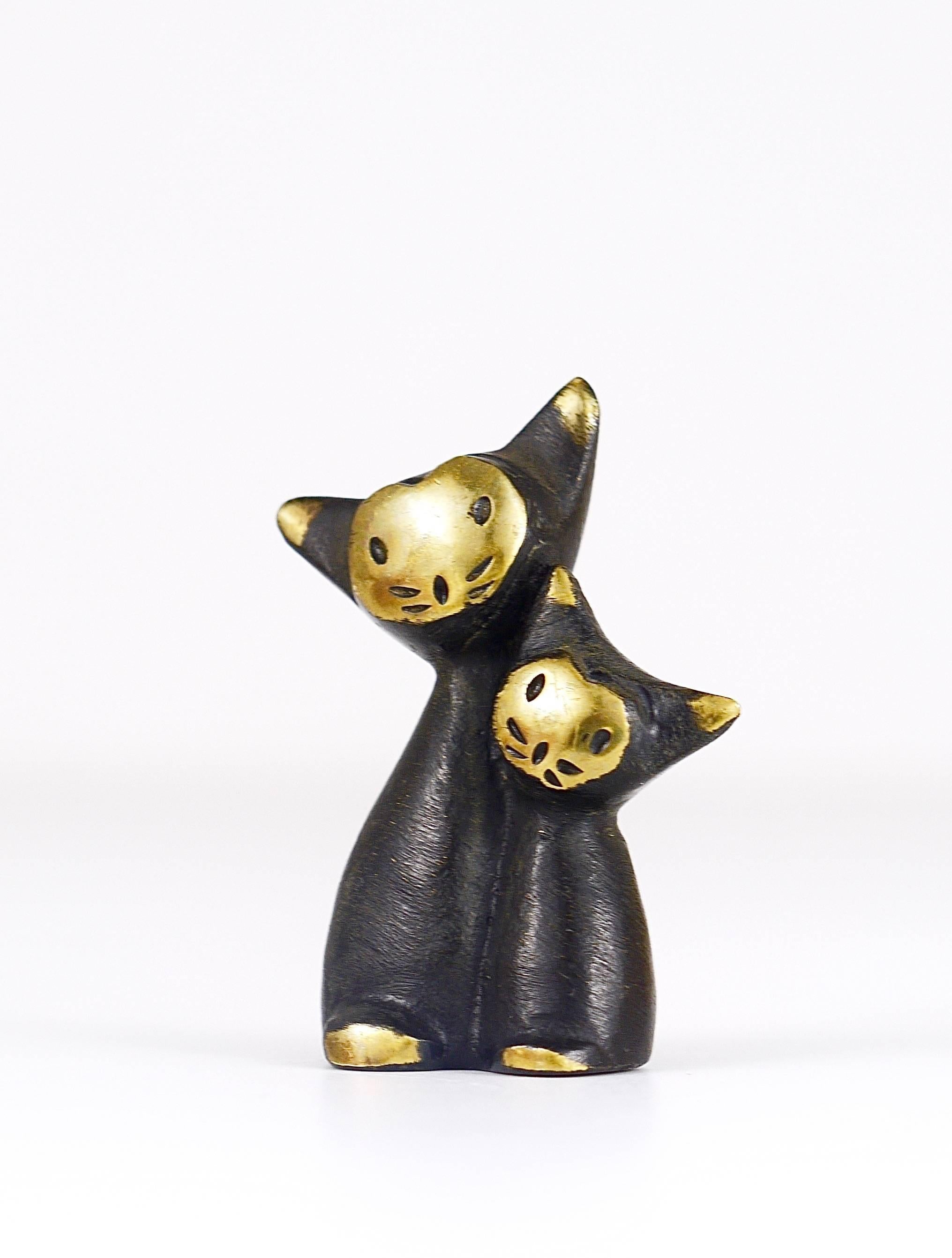 A charming cat family sculpture, displaying a cat and a kitten from the 1950s. Made of brass. A humorous design by Walter Bosse, executed by Hertha Baller Austria in the 1950s. In excellent condition. Marked.
