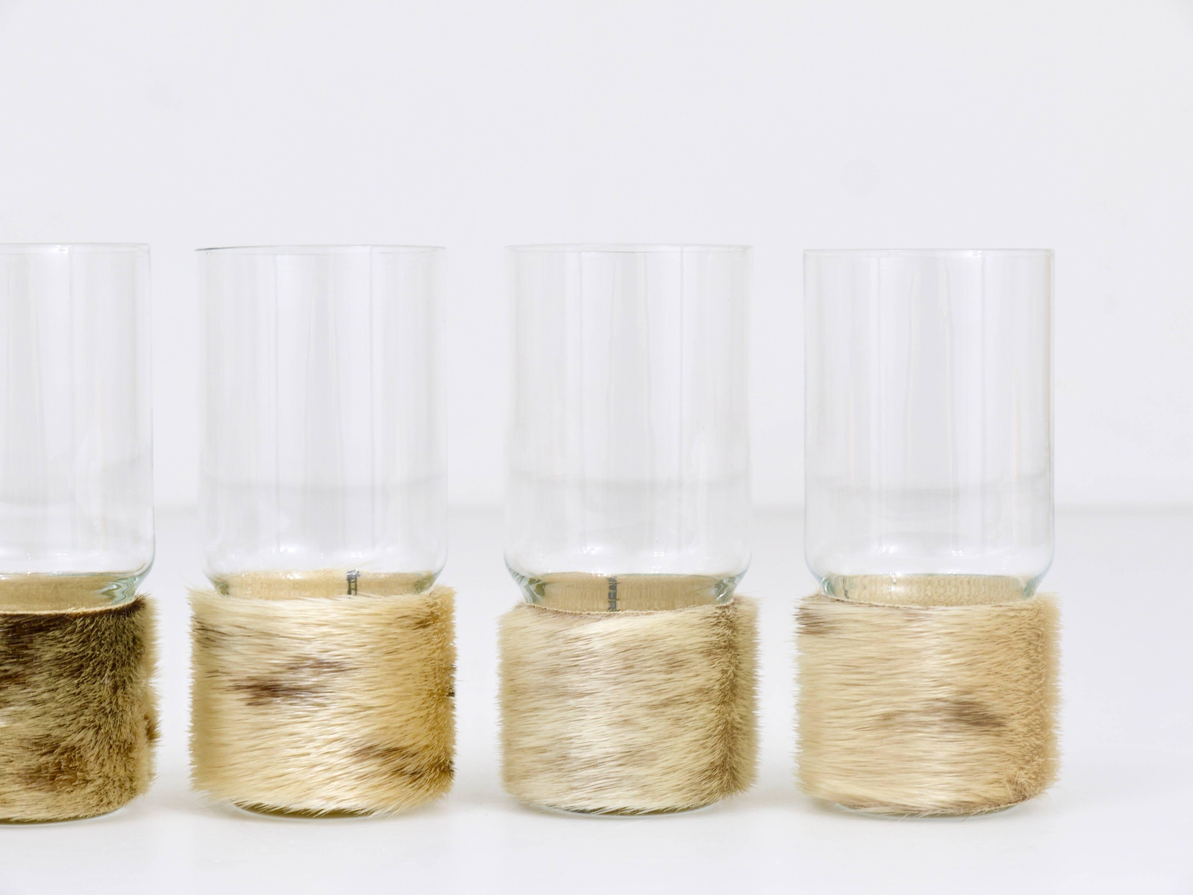 A set of six beautiful modernist drinking glasses with bases wrapped in fur from the 1950s.  In excellent condition, unused, in its original box. We offer other similar drinking glasses, tableware and other design object in our other listings.