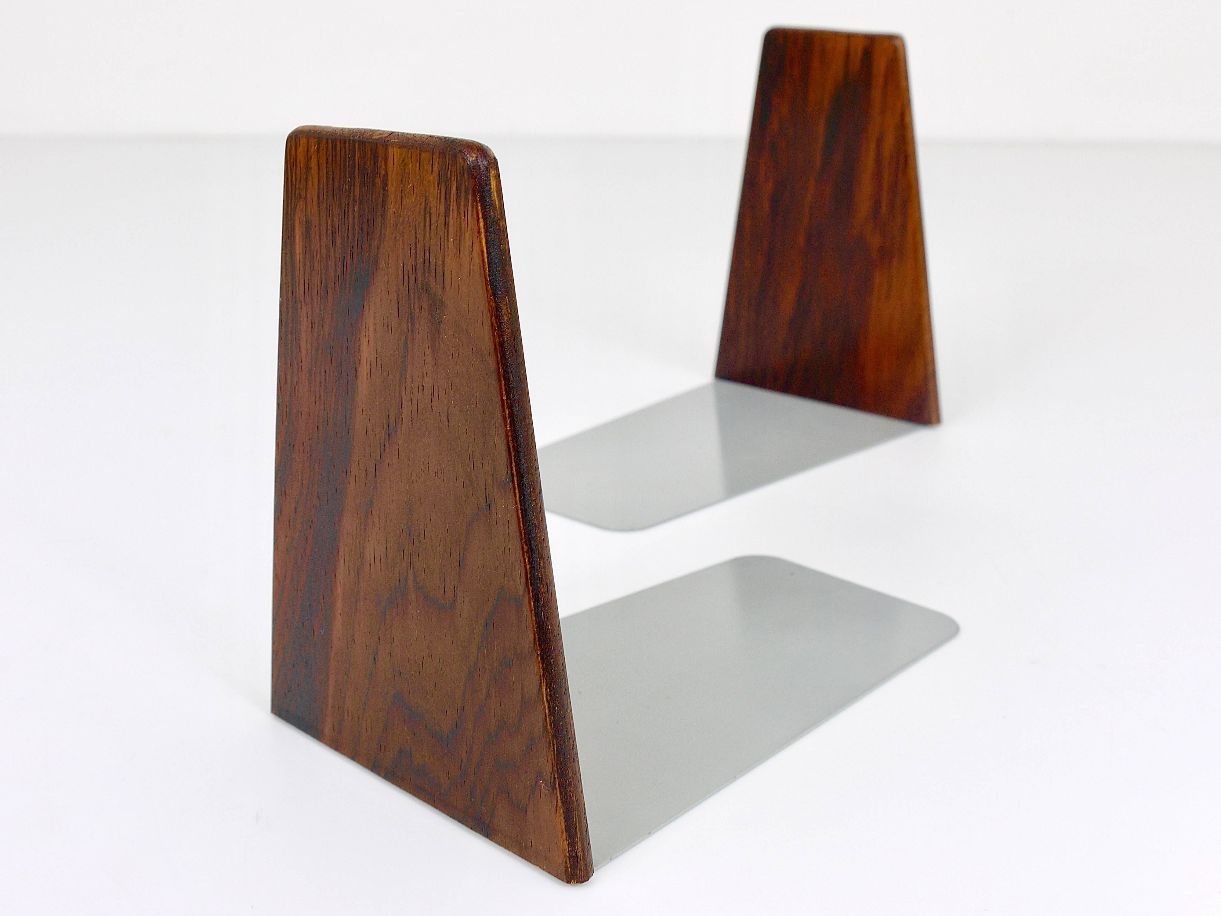 A beautiful pair of mid-century bookends, crafted in Denmark during the 1960s. These were designed by Kai Kristiansen and produced by Fm Moebler. Made from finely grained rosewood with bases of grey lacquered metal, they are in very good condition,