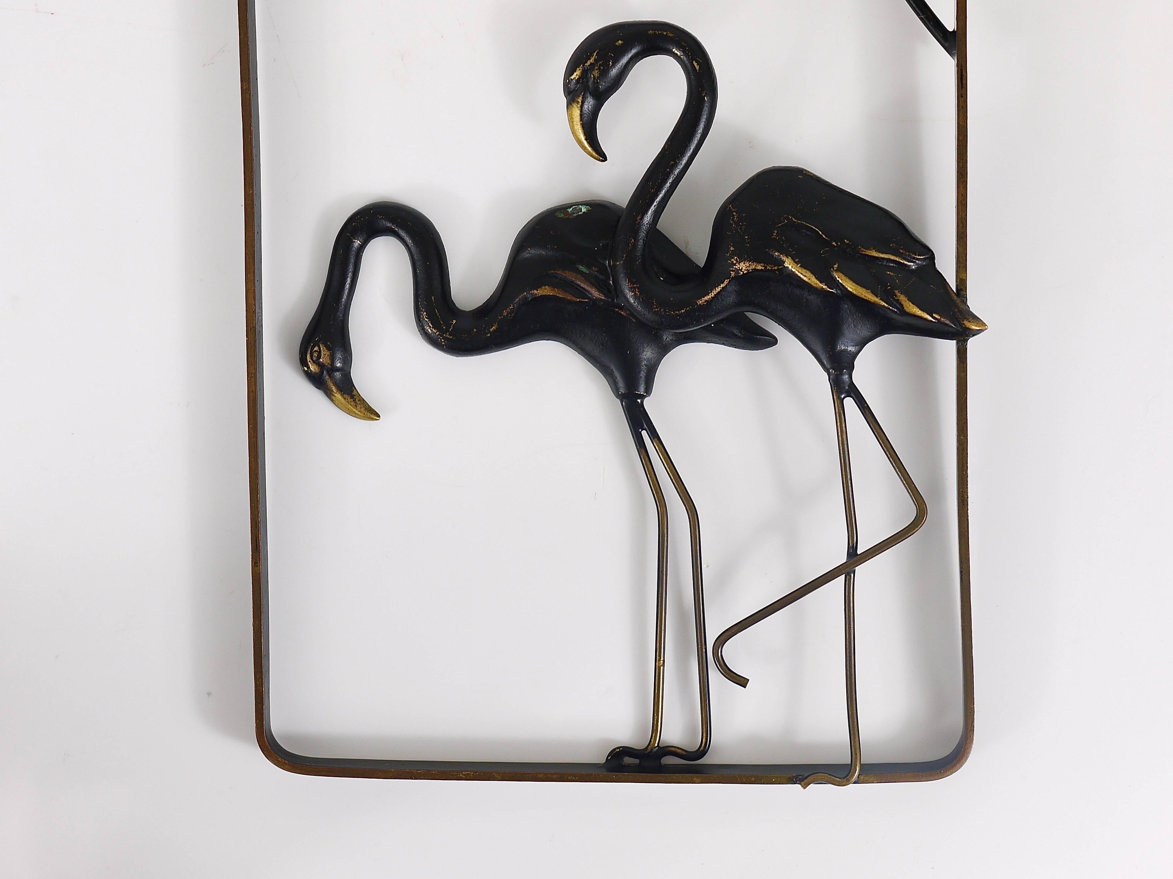A lovely Mid-Century mural, displaying two flamingos on a frame, all made of brass. A charming design by Walter Bosse, manufactured in the 1950s by Hertha Baller, Austria. In excellent condition. We offer more Walter Bosse objects in our other