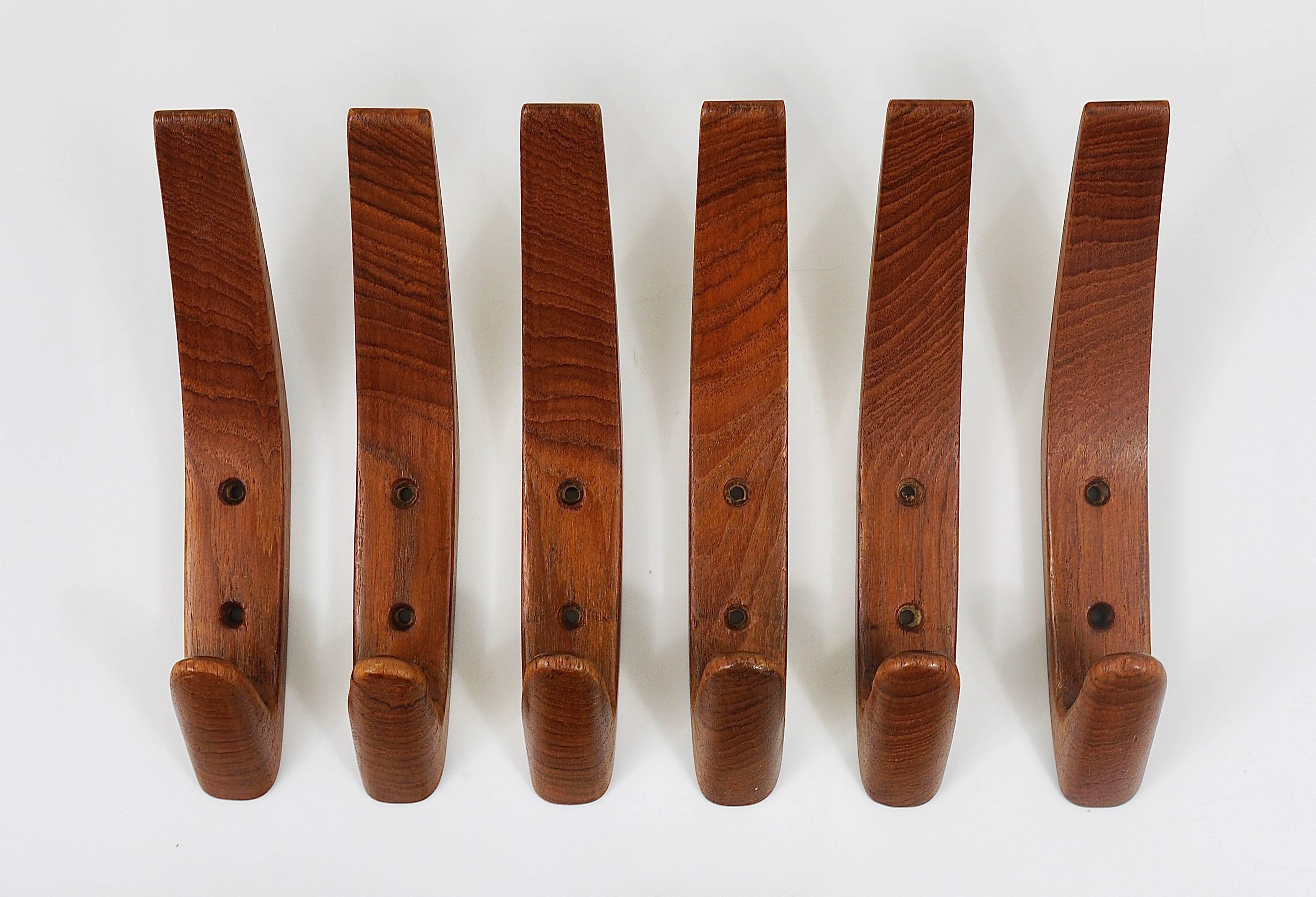 A set of six beautiful Mid-Century wall hooks from the 1950s. Teakwood, made in Denmark, in excellent condition.