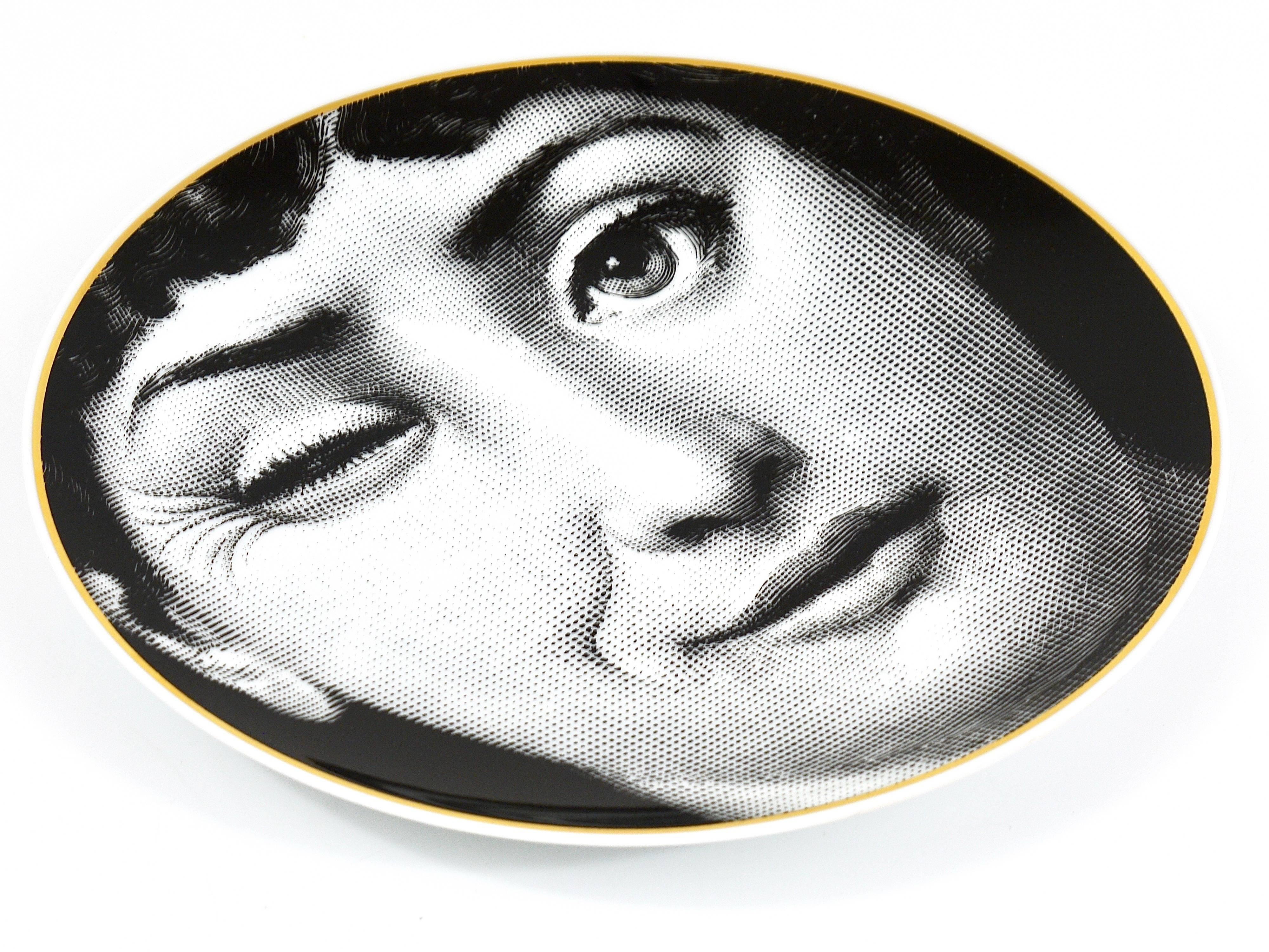 A gold-rimmed black and white collectors plate from the series 