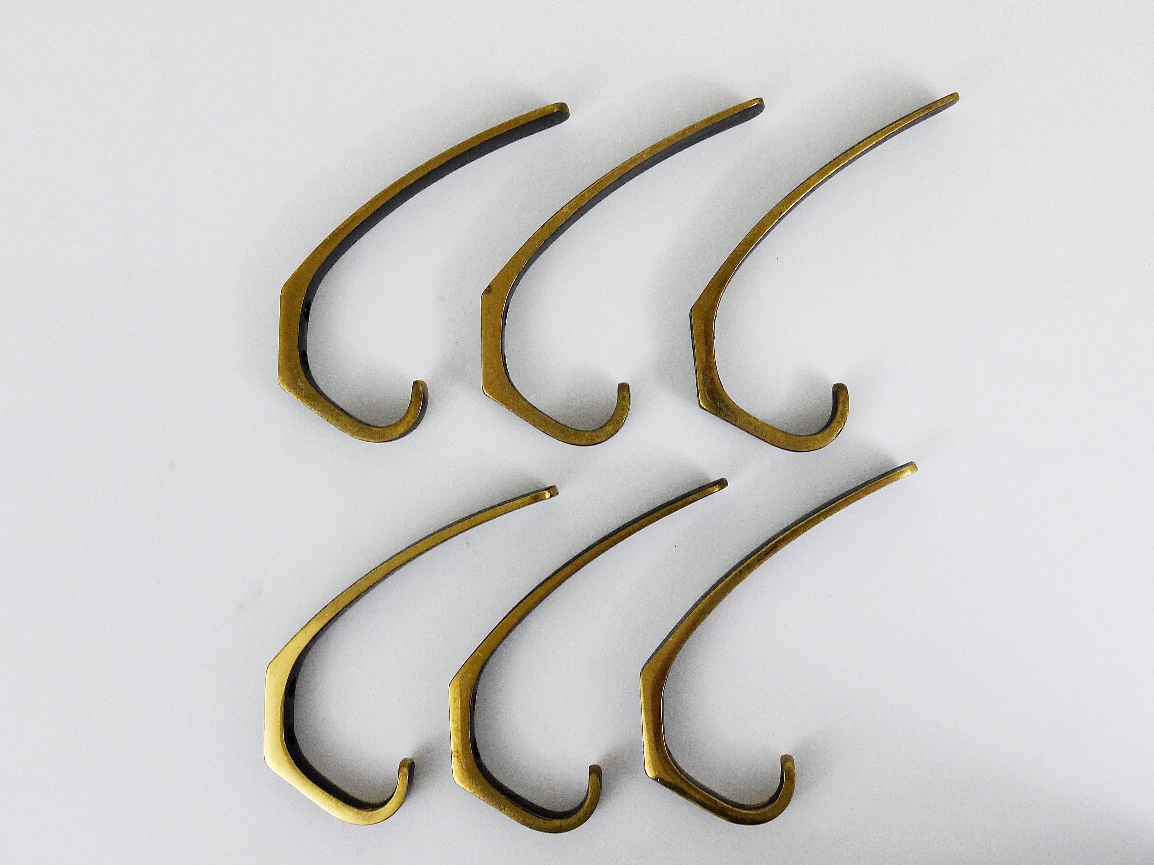 A set of up to two beautiful Austrian modernist wall hooks, made of black-finished brass, executed in the 1950s by Hertha Baller, Austria. In good condition, with nice patina. Sold and priced per piece.

We offer more Mid-Century brass wall hooks in