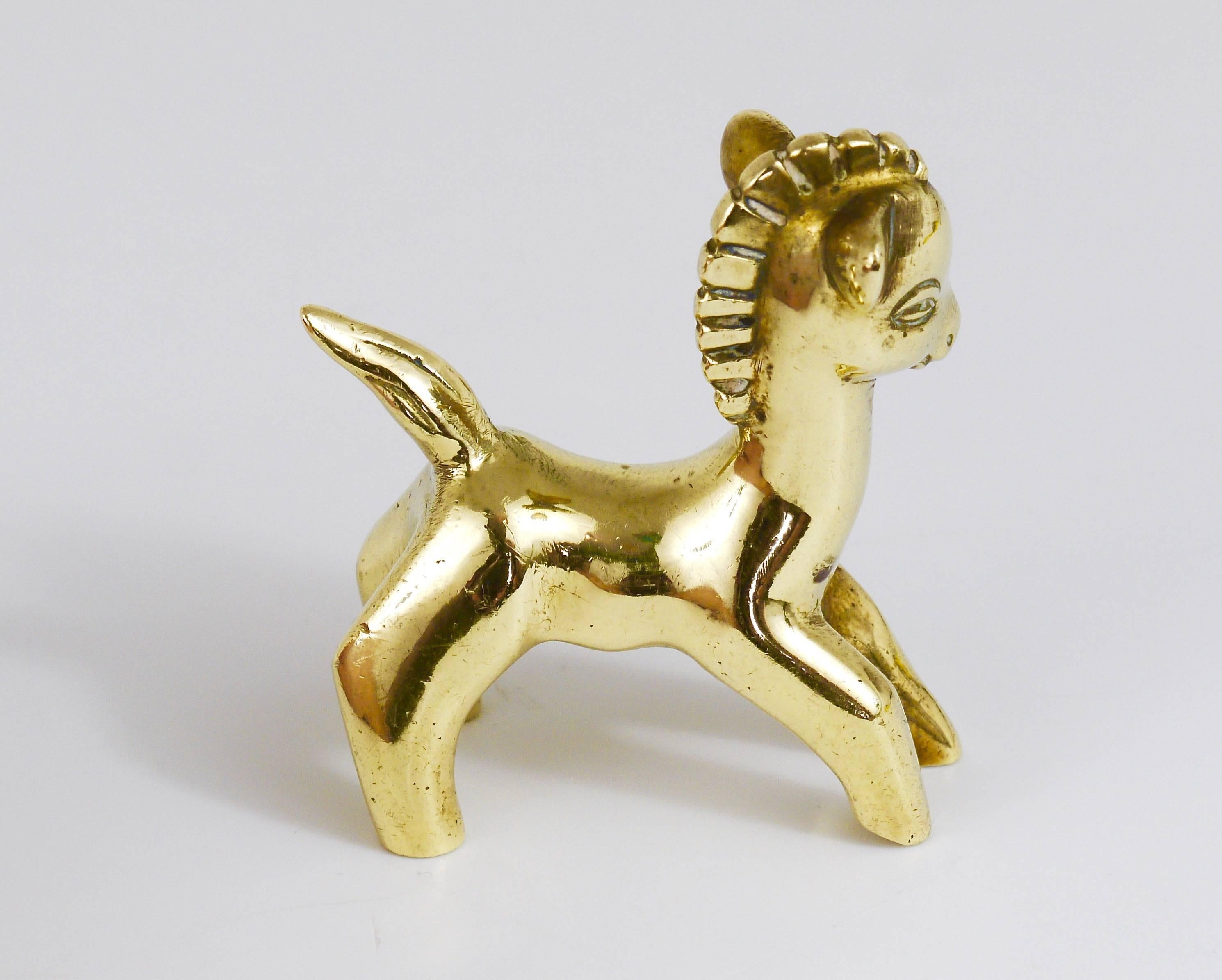 A lovely horse foal sculpture made of brass from the 1950s. Designed by Walter Bosse, executed by Hertha Baller. In very good condition with charming patina. We offer more Walter Bosse brass objects in our other listings.