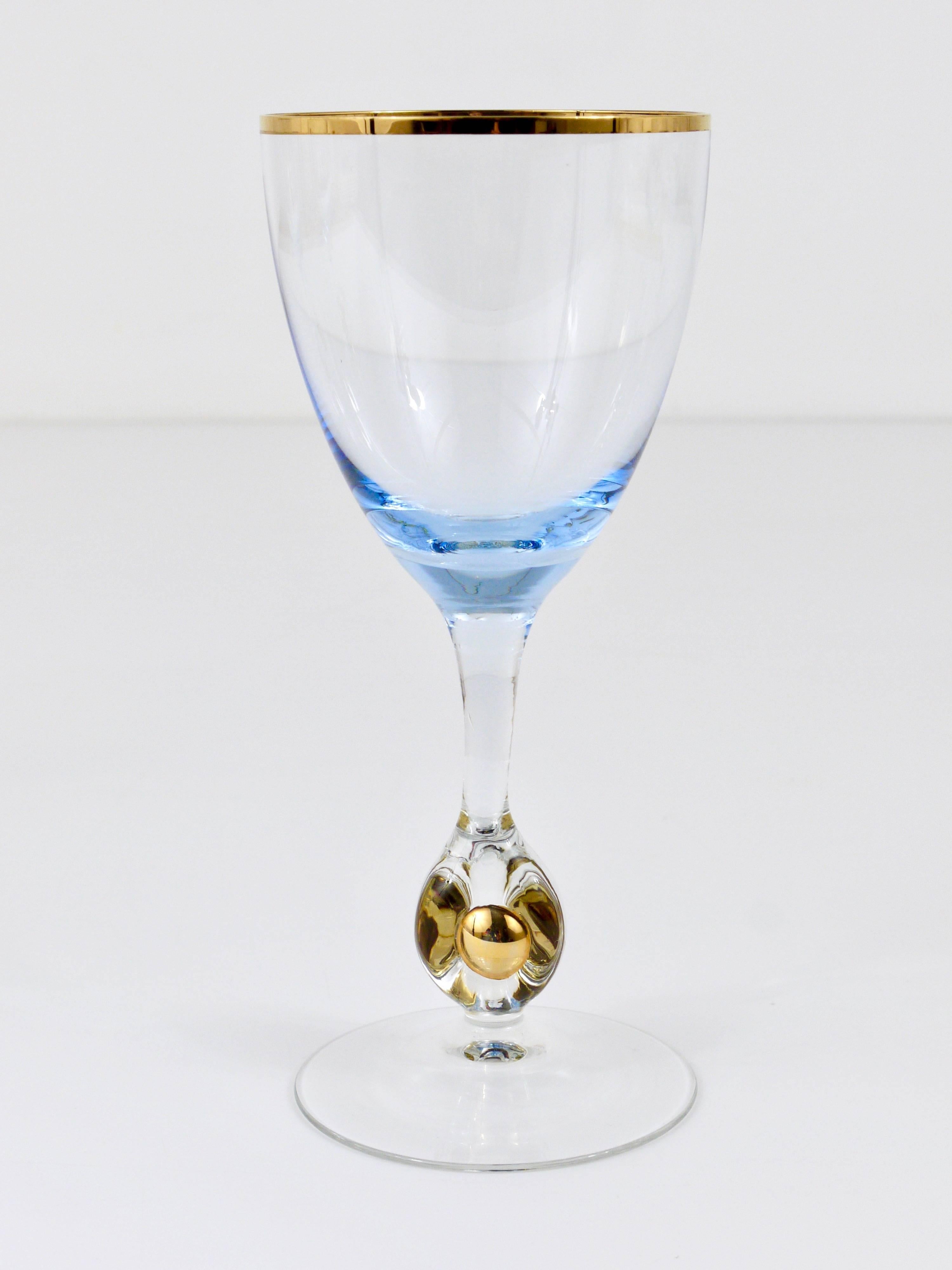 A set of six beautiful handblown wine or water glasses, made of clear and light blue glass with gold rim and a golden ball in the stem. Made by Lyngby Glassworks in Denmark in the 1960s. In excellent condition, we think, the glasses are unused.
