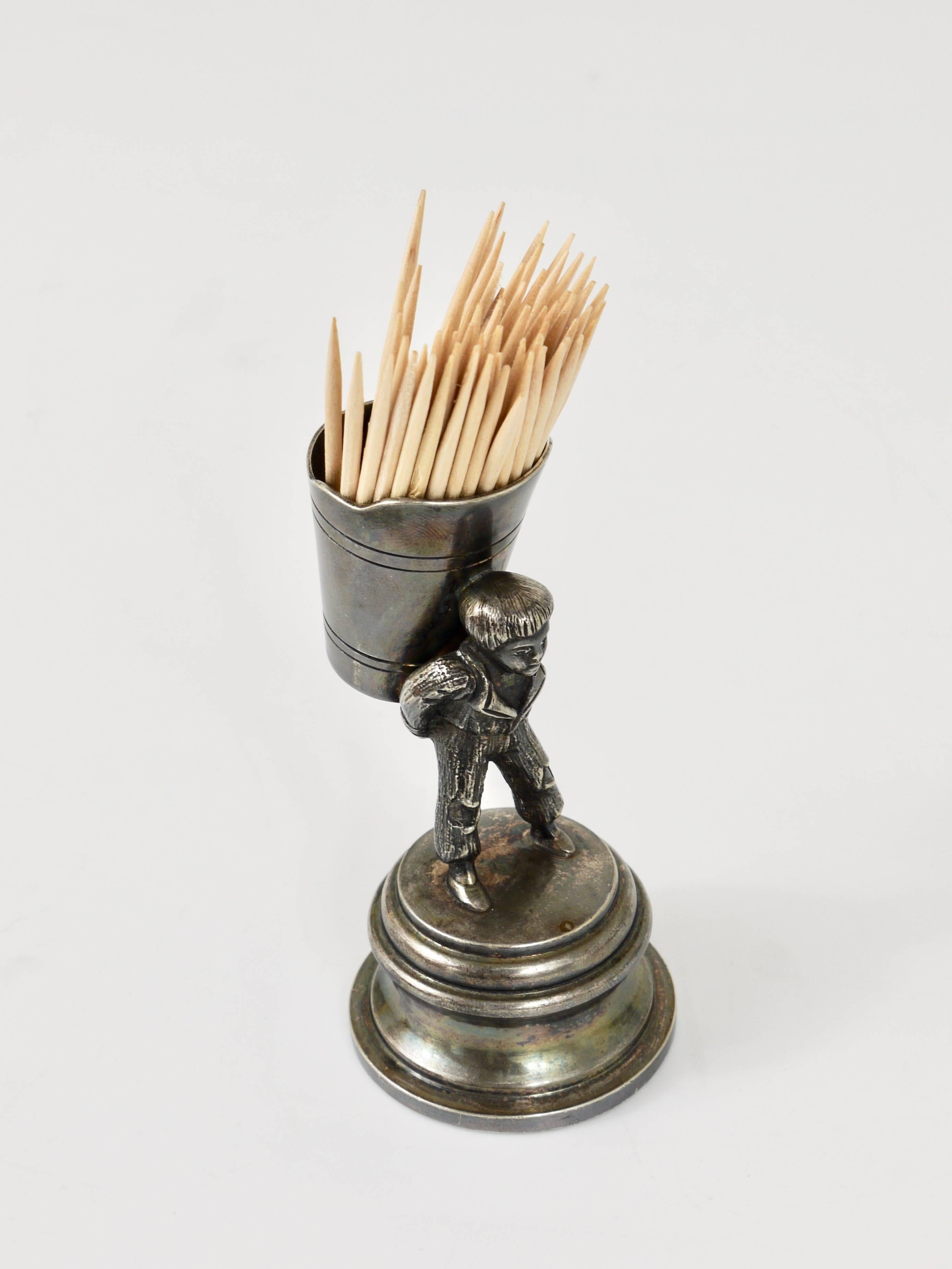 A unique and unconventional silver plated Art Nouveau toothpick stand or dispenser from the 1920s. The toothpick holder depicts a boy with a barrel on his back during a grape harvest in the vineyard. Executed by Moritz Hacker (1849-1932) in Vienna,