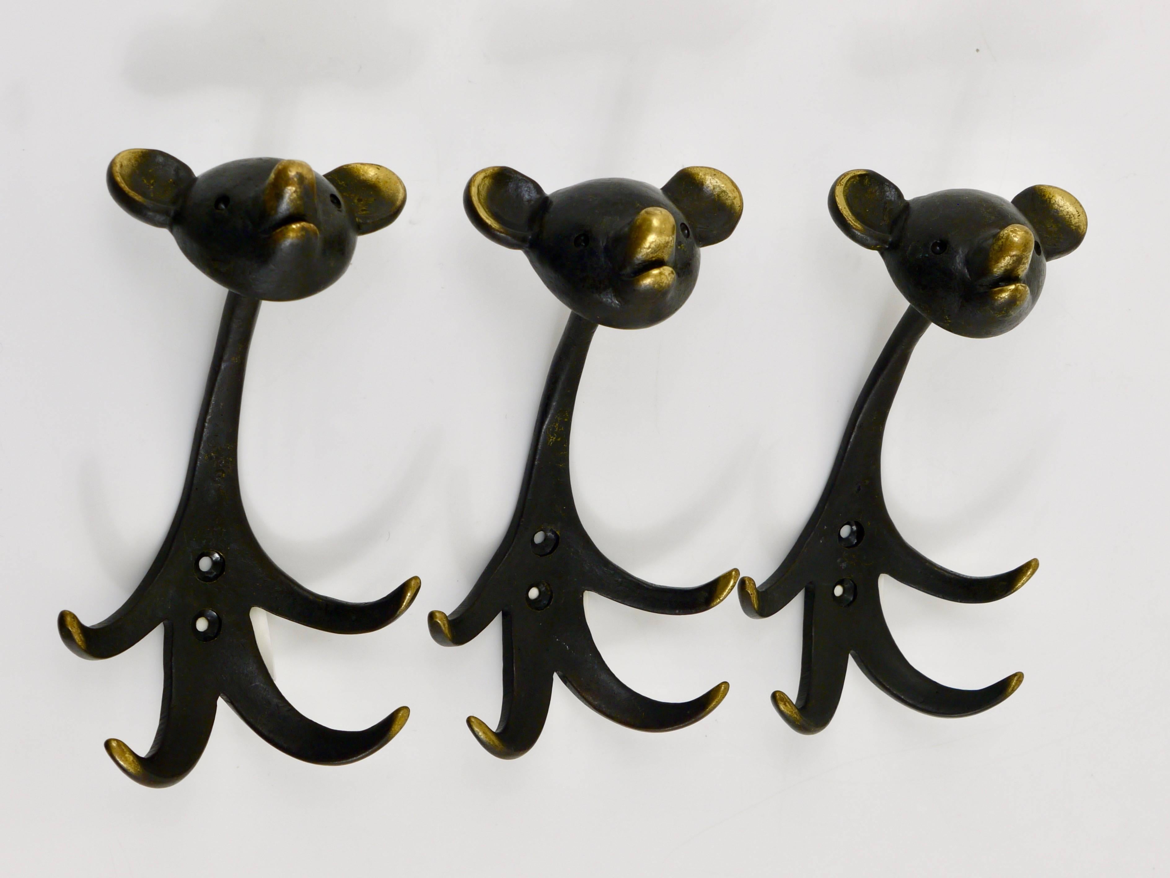 Up to two Austrian modernist brass wall coat hooks, displaying a bear. A humorous design by Walter Bosse, executed by Hertha Baller Austria in the 1950s. Made of black finished brass. In excellent condition with nice patina. Each hook has a height