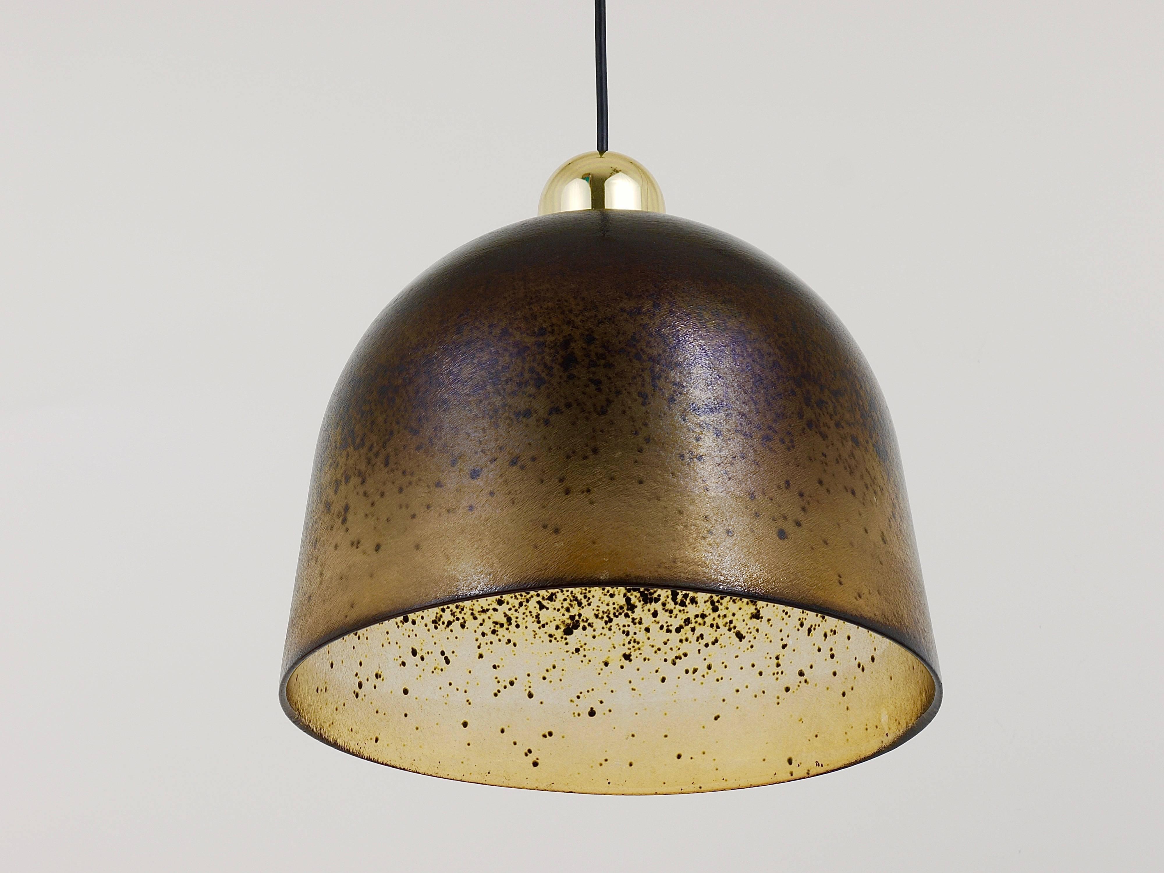 A beautiful pendant light with a solid handblown lampshade, made of brown and light-brown glass. Executed in the 1970s by Peill and Putzler Germany. A stunning lamp, which makes wonderful light. In very good condition. Marked on the lampshade. One