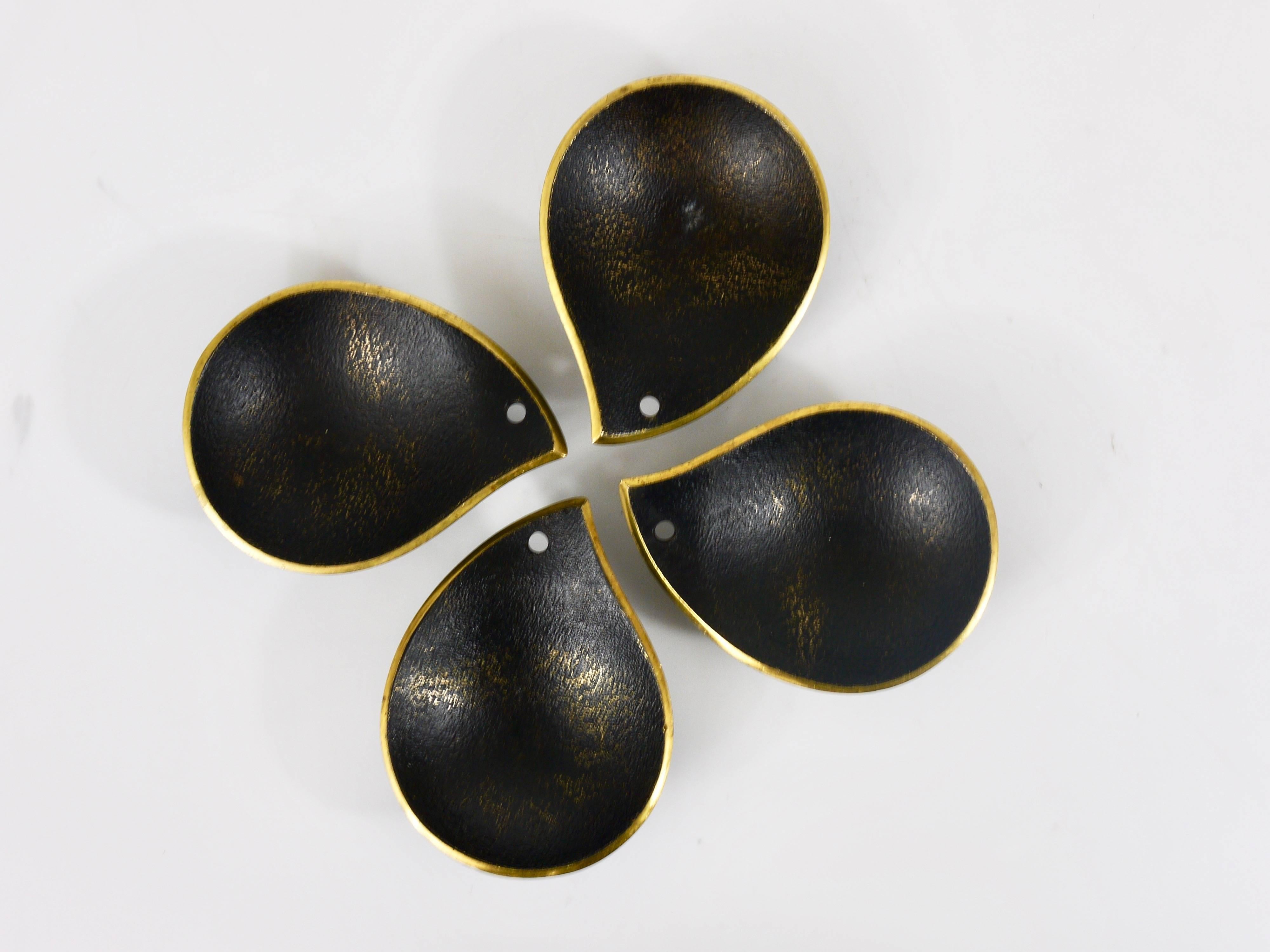 A charming set of four beautiful black-finished modernist drop-shaped brass ashtrays with stand from the 1950s. Made in Austria by Richard Rohac. In good condition with nice patina.