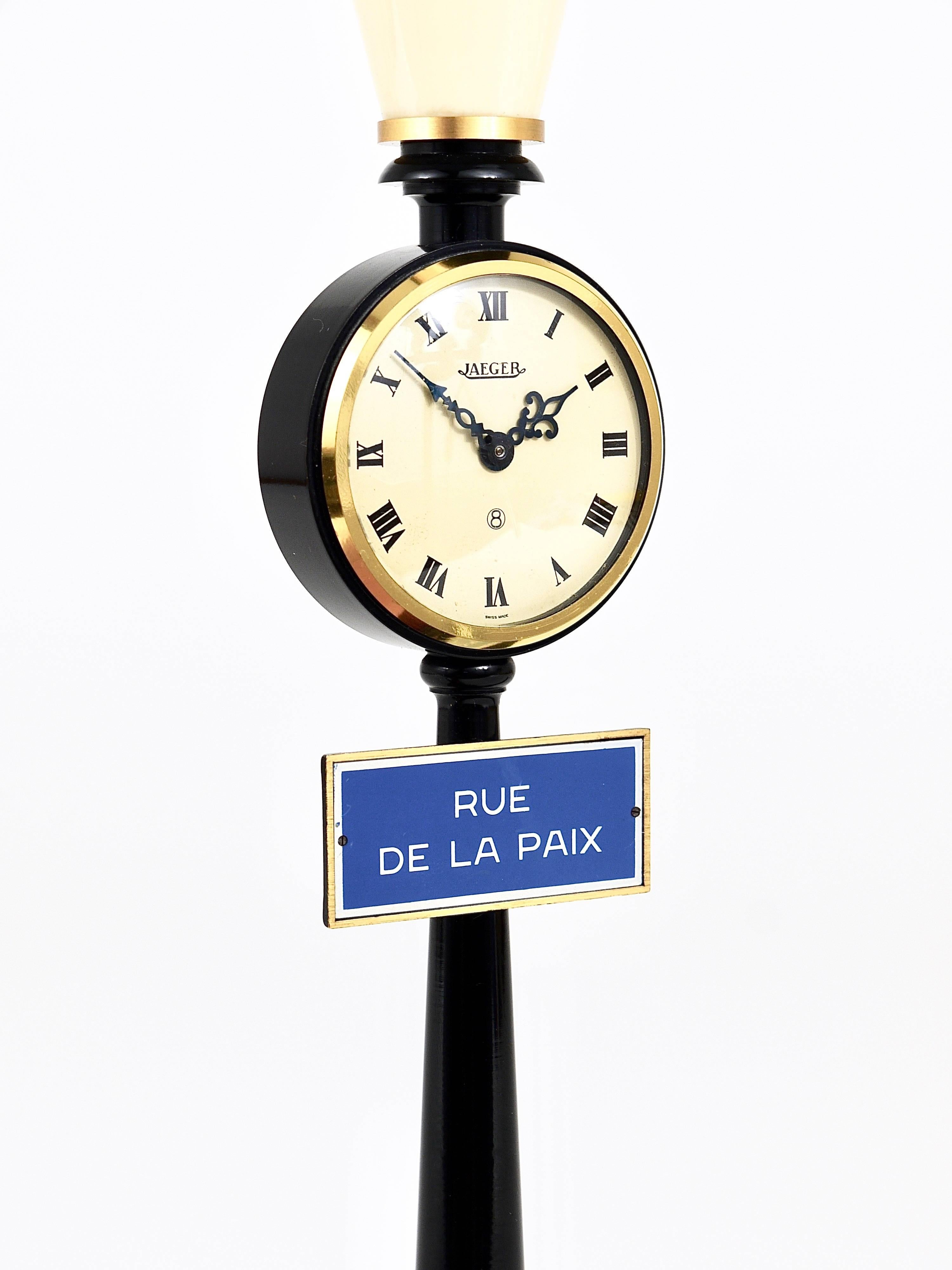 A beautiful black and gold desk or table clock in the shape a lantern / street light. Manufactured in the 1960s by Jaeger LeCoultre, Switzerland. This nice clock has a mechanical 8-days movement with manual winding. The clock works perfectly and is