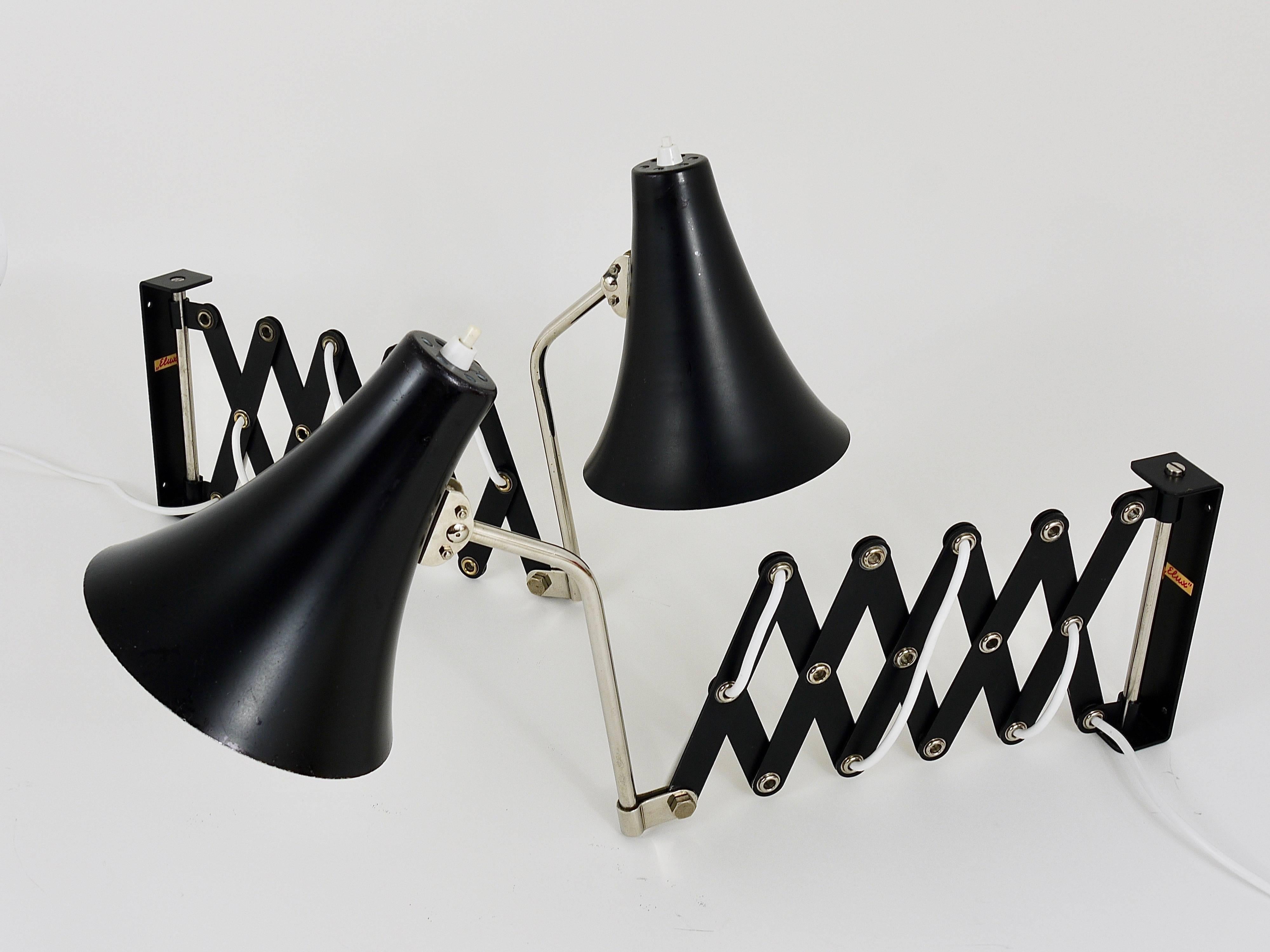 Up to two identical black and chromed scissor wall lamps / sconces from the 1960s, manufactured by Elux Austria. Adjustable and rotatable to all angles, in very good condition with marginal signs of age on the lampshades. Two lights are available,