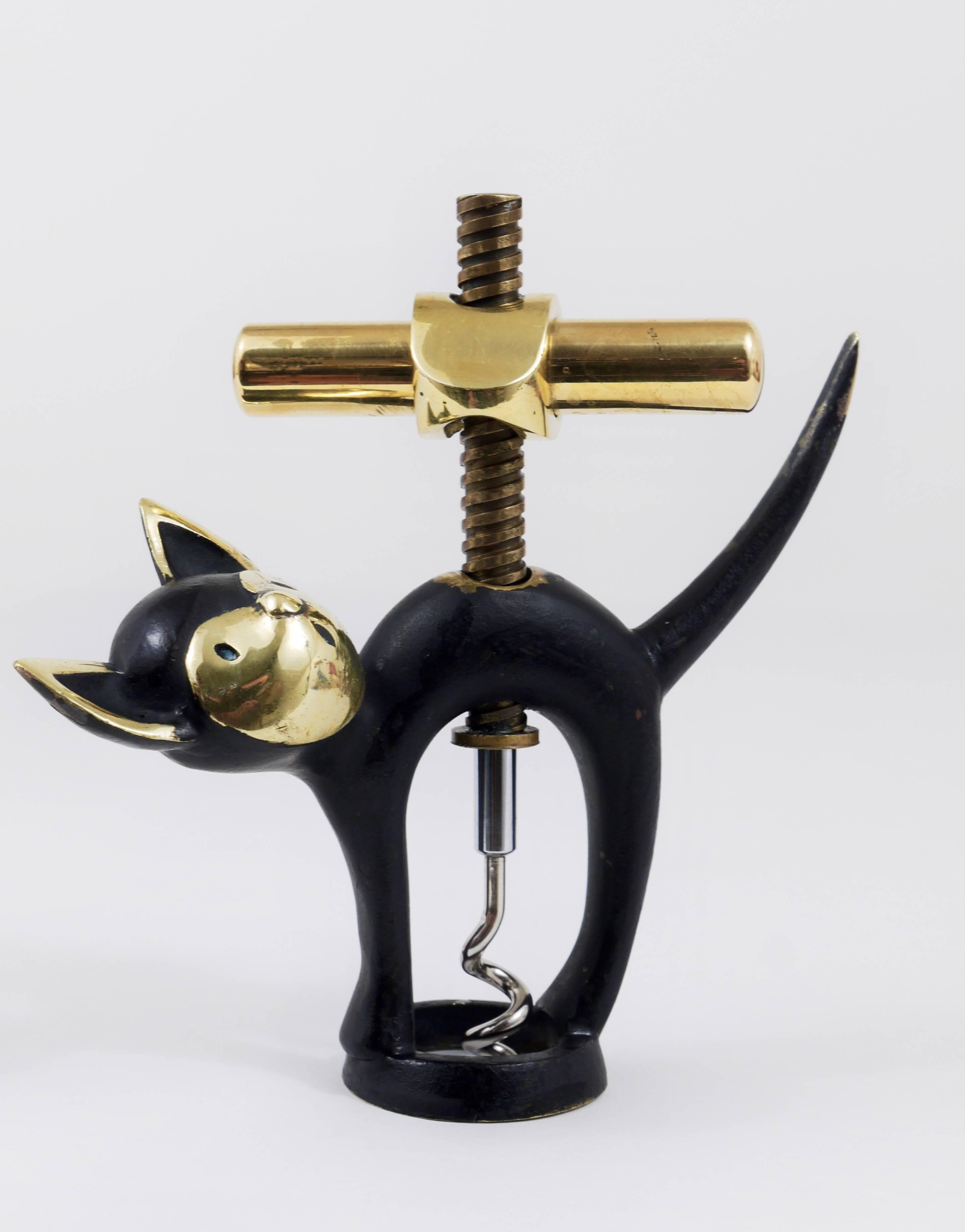 A charming Mid-Century bottle opener or cork screw, displaying a cat. A very humorous design by Walter Bosse, executed by Hertha Baller Austria in the 1950s. Made of brass, in good condition with charming patina on the brass.

We offer more Walter
