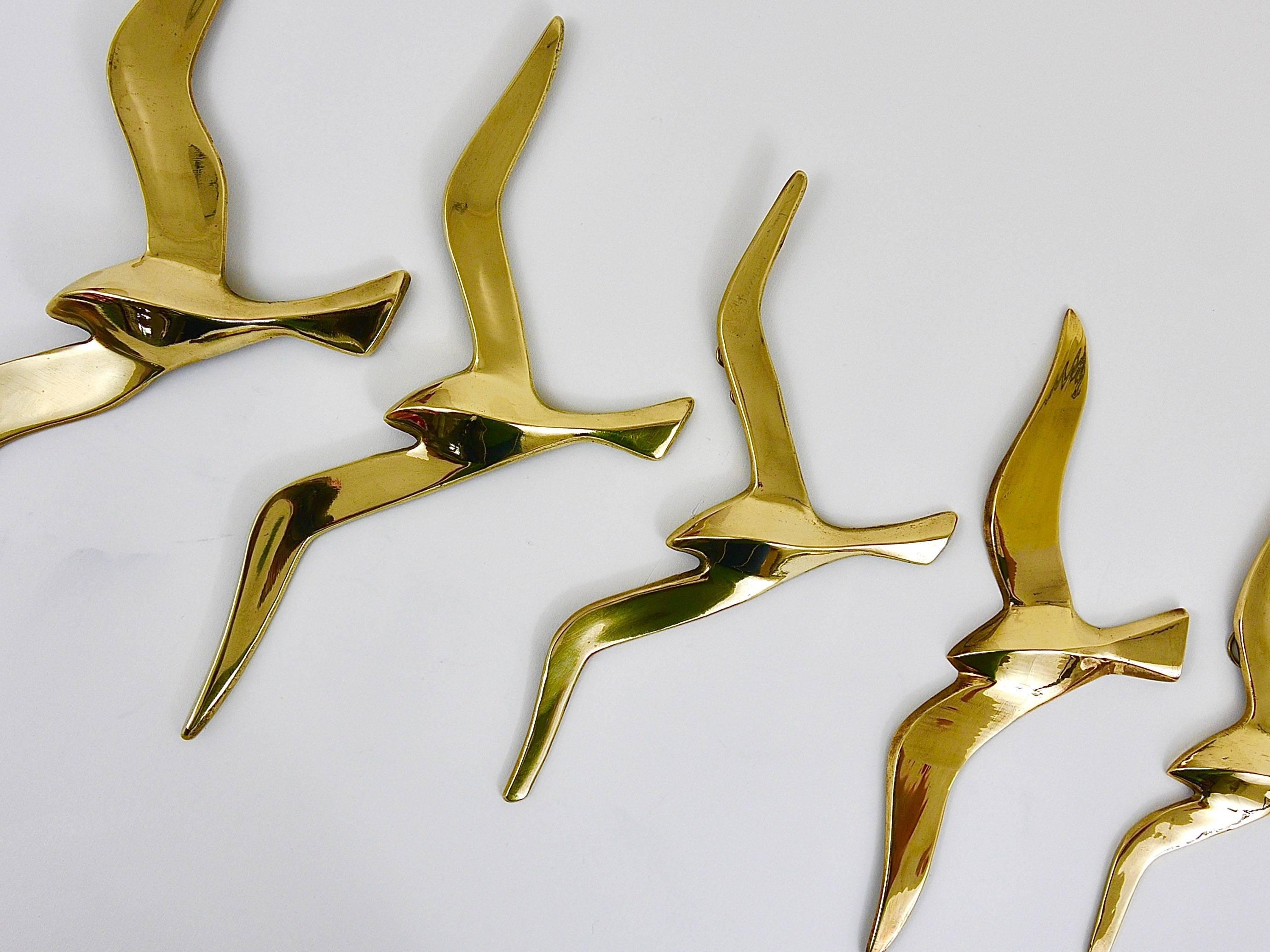A set of five lovely wall-mounted modernist birds / gulls. Handmade of brass in the 1950s in Austria. Gently polished, in excellent condition. Width of the birds: 14 to 8 inches.