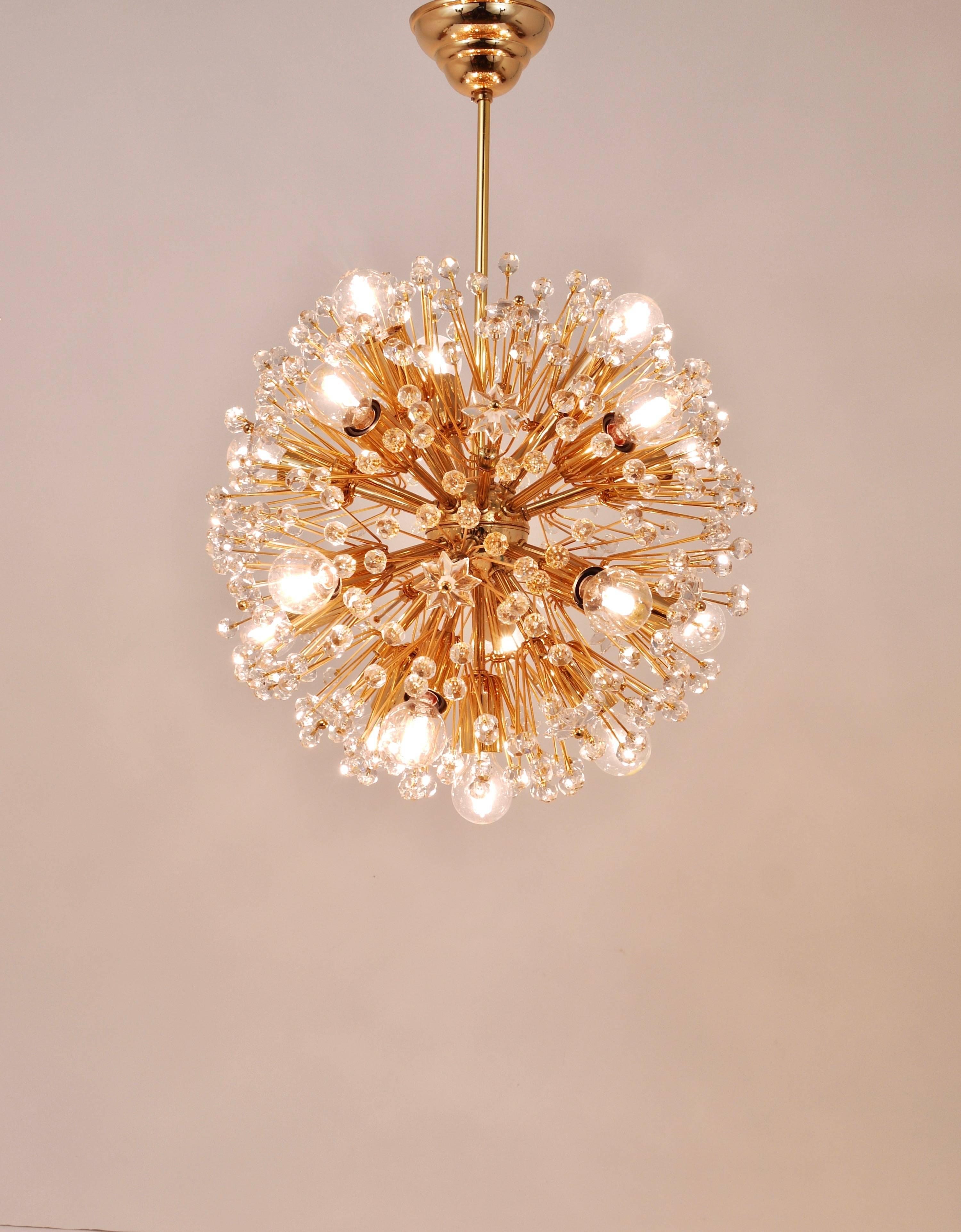 A beautiful brass and crystal snowflake blow ball sputnik chandelier. An exclusive 24-Carat gold-plated model. Made in Austria in the 1970s, in the manner of Emil Stejnar/Rupert Nikoll. Made of gold-plated brass, fully covered with Austrian crystal