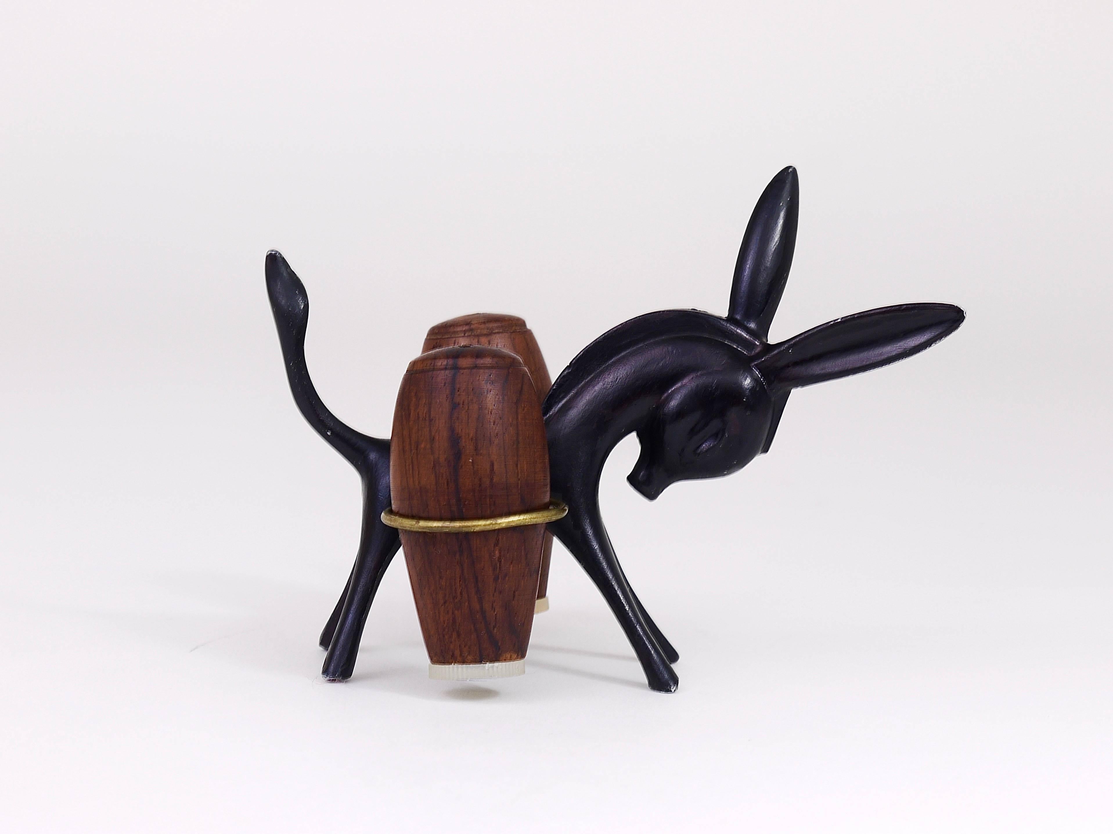 A charming Austrian midcentury shaker set, displaying a donkey. A very humorous design by Walter Bosse, executed by Hertha Baller Austria in the 1950s. Made of metal and walnut wood. In very good condition with marginal patina.