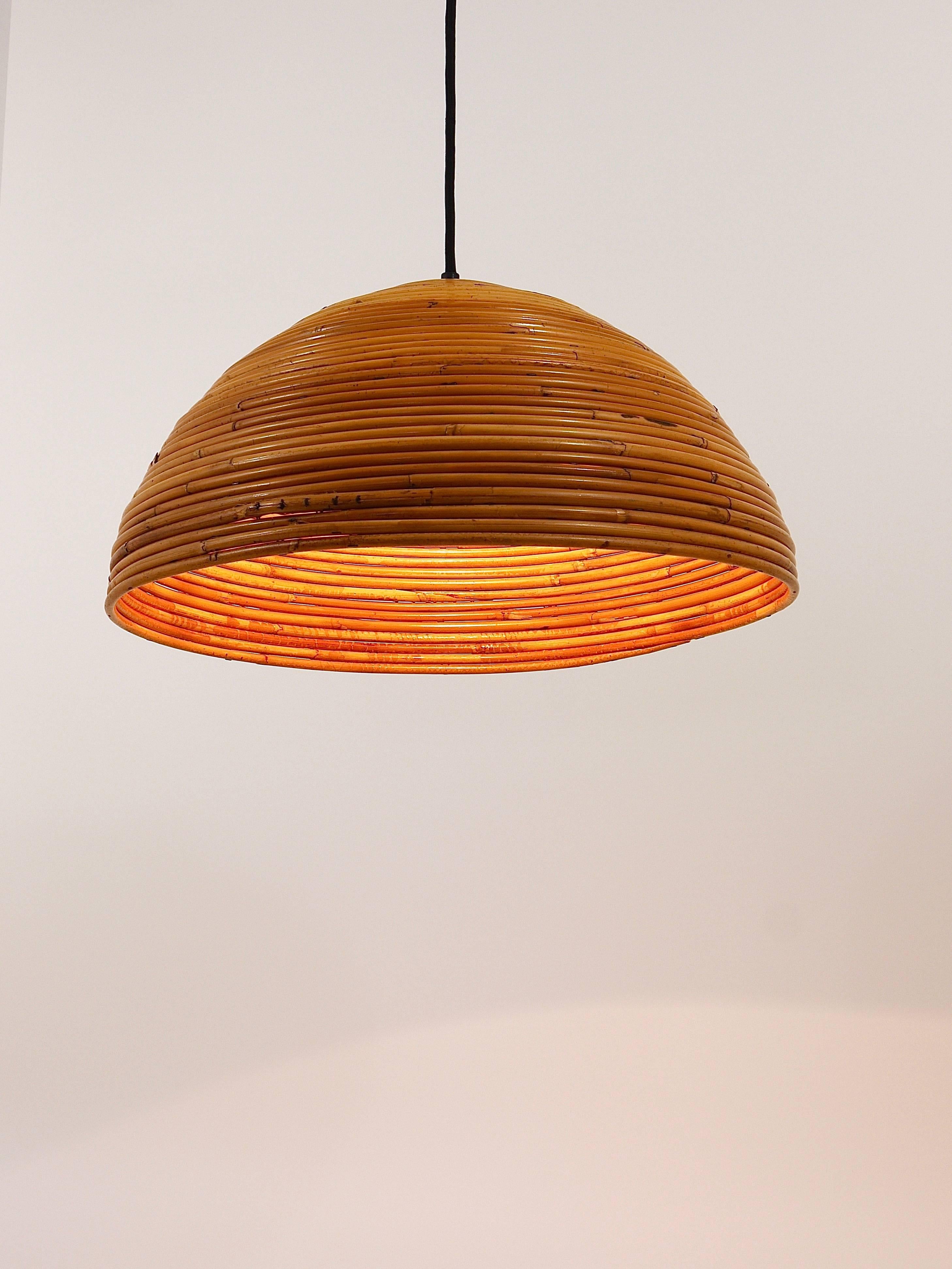 A beautiful hemisphere modernist pendant lamp from the 1960s, made in France. The lampshade is made of bamboo / rattan. In excellent condition, rewired with a black fabric cord. The lampshade has a diameter of 18 inand a height of 9 in, the cord is