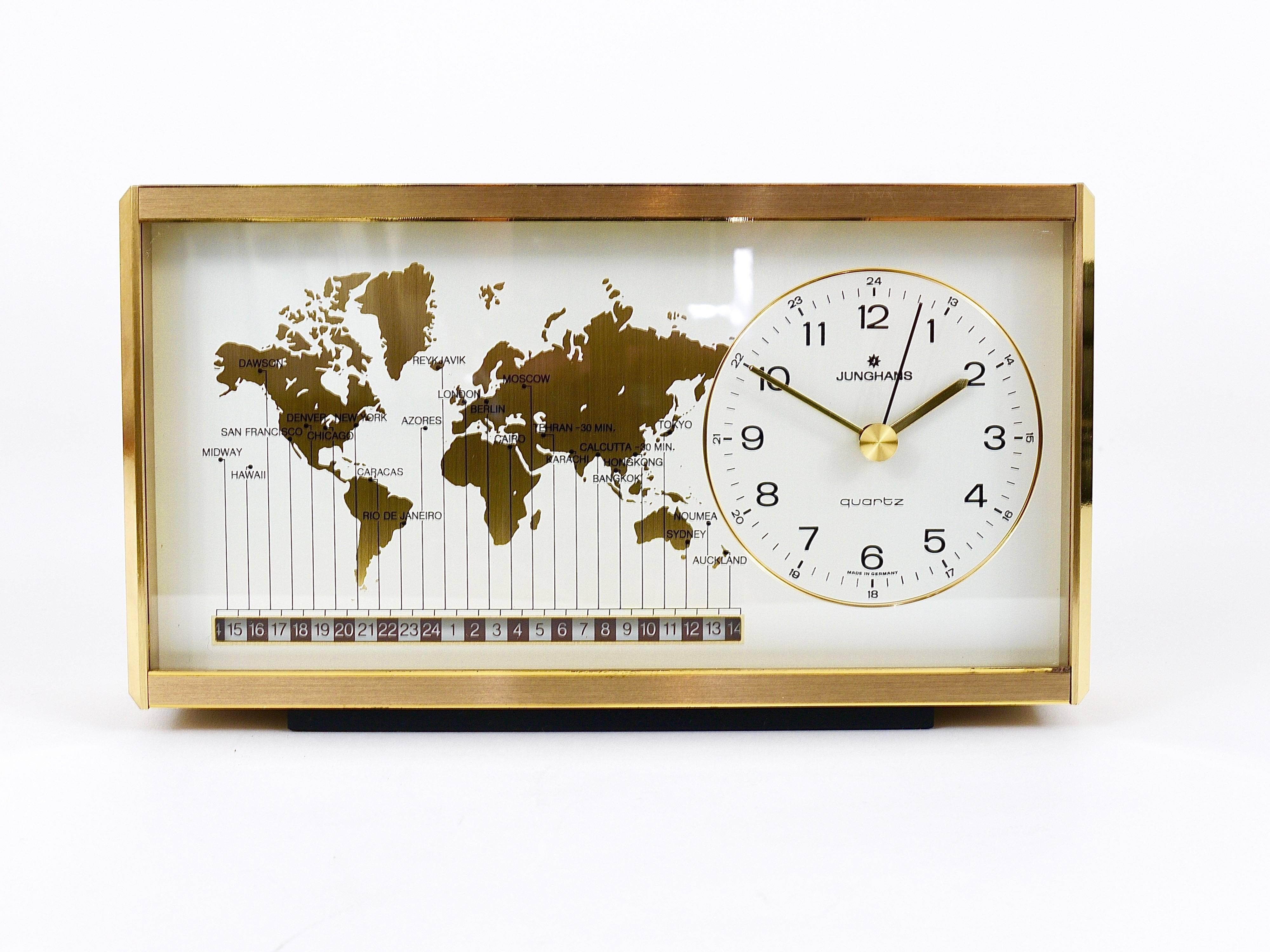 A beautiful modernist desk or table clock with a world map clocks face and world time zones. Has a brushed and partly polished brass housing. Executed in the 1970s by Junghans Germany. An elegant and solid piece in very good condition with marginal