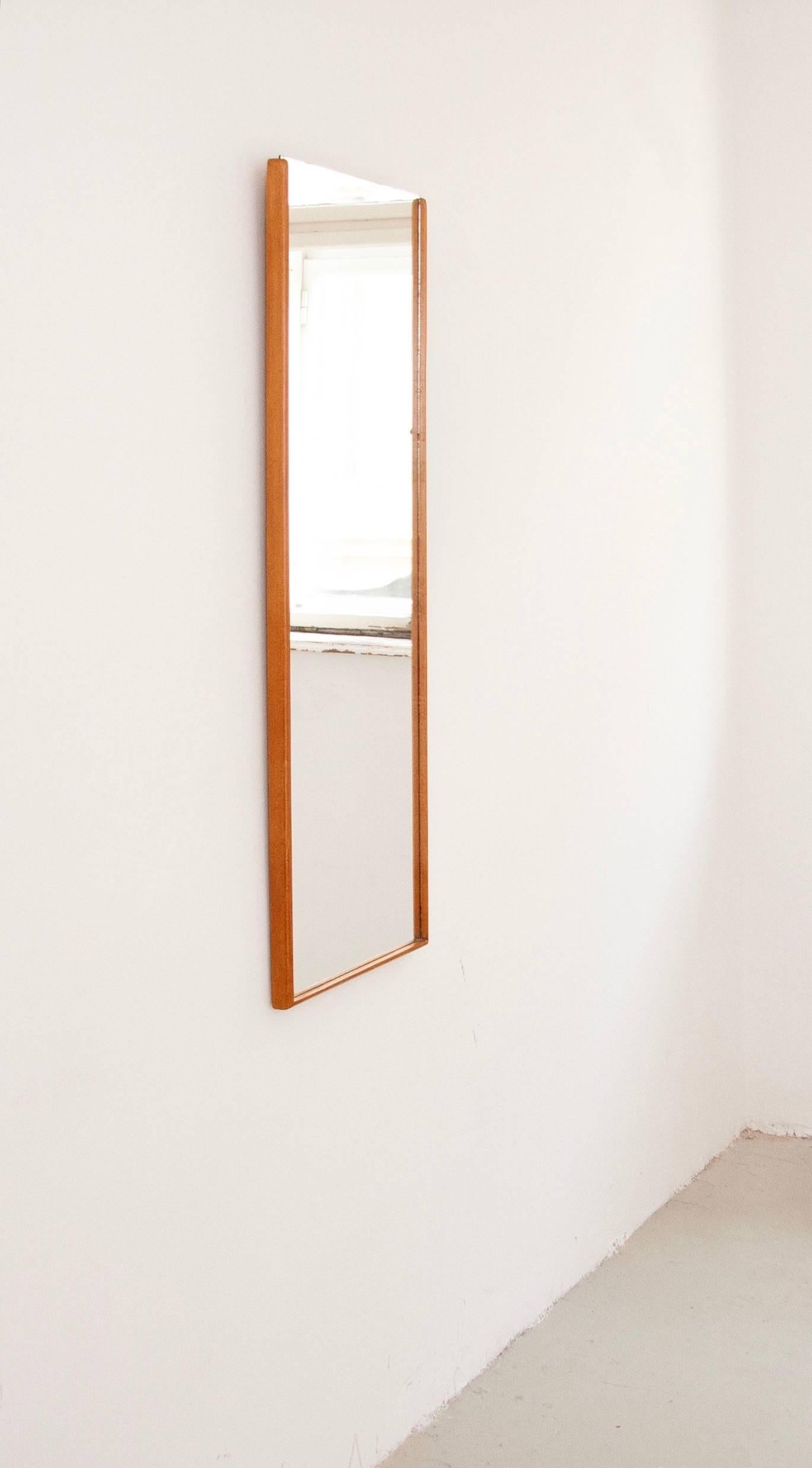 A wonderful and simple Austrian modernist wall mirror with a fine wooden frame from the 1950s. In excellent condition. 