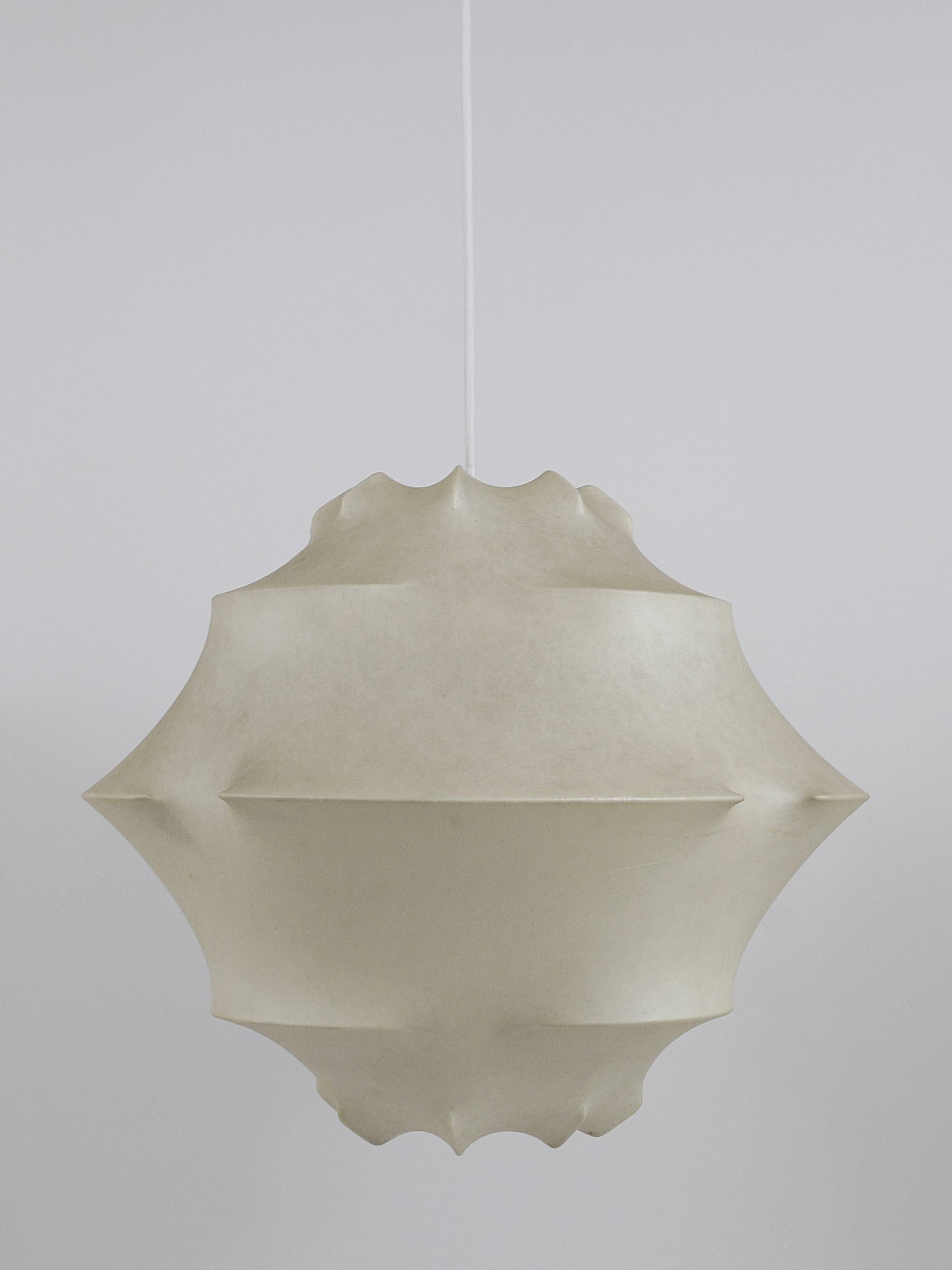Un magnifique lustre cocon organique du milieu du siècle dernier:: datant des années 1960:: conçu par Achille et Pier Giacomo Castiglioni:: exécuté par Flos/Italie. Cadre en métal blanc recouvert de résine synthétique. Sur un cordon en tissu blanc