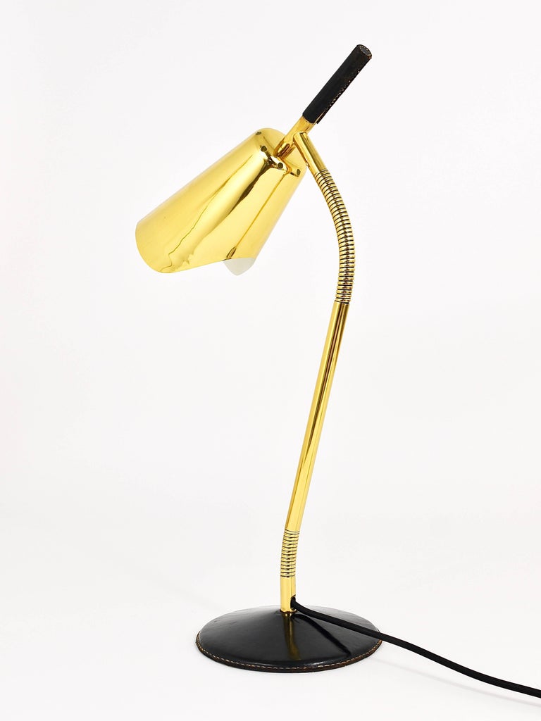 We are proud to offer this very rare and beautiful table or desk lamp from the 1950s. Designed and executed by Carl Aubock, Austria. This lamp is made of brass and has a leather-covered base and handle on its top. Straight and simple but functional