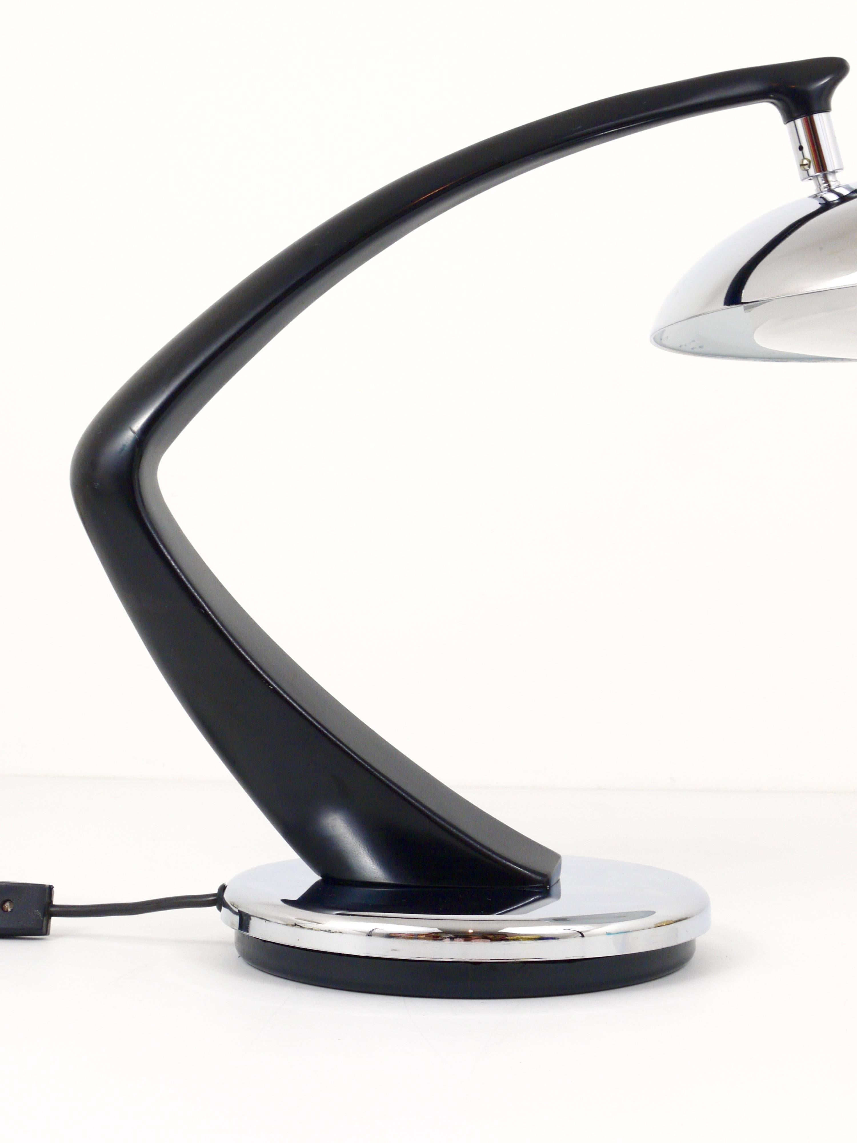 A beautiful black and chrome boomerang table lamp, executed in the 1960s by Fase, Madrid. Have a swivel base and an adjustable lampshade with two sockets. In very good condition.