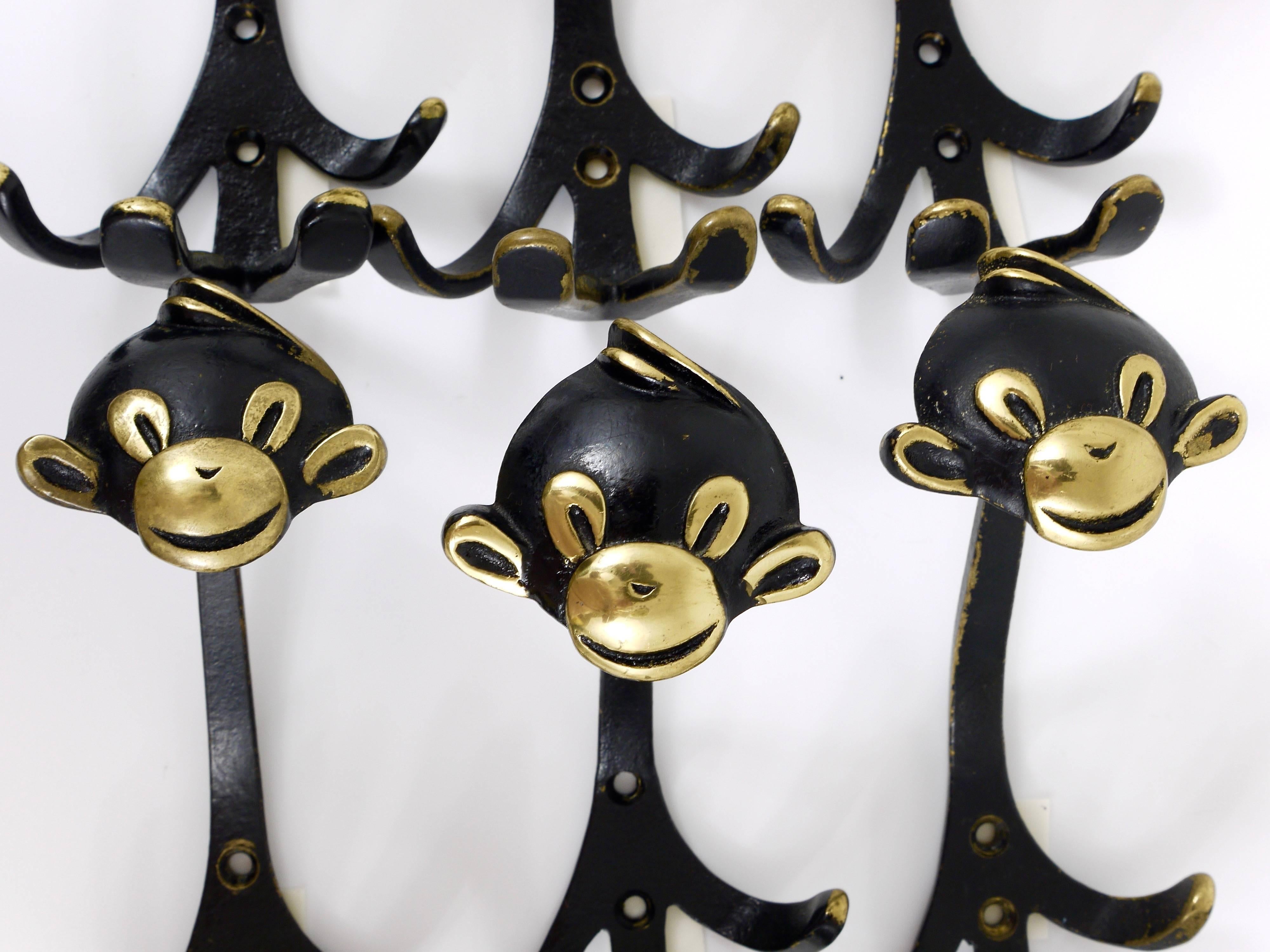 Up to four Austrian modernist brass wall coat hooks, displaying a monkey. A very humorous design by Walter Bosse, executed by Hertha Baller Austria in the 1950s. Made of black finished brass. In good condition with nice patina. Each hook has a