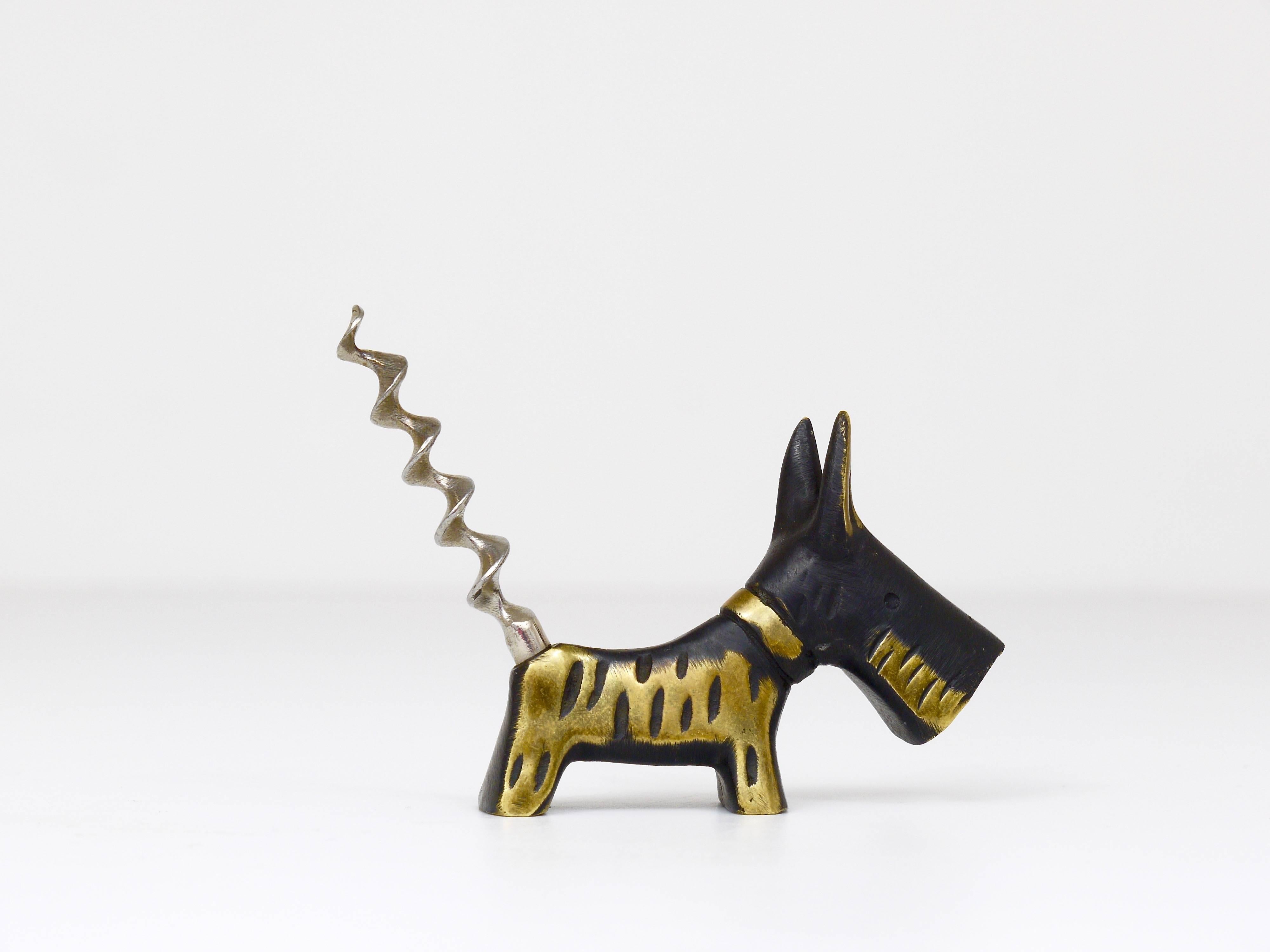 A charming Austrian corkscrew bottle opener, displaying a nice scotch terrier. A very humorous design by Walter Bosse, executed by Hertha Baller Austria in the 1950s. Made of brass, in very good condition, marked.