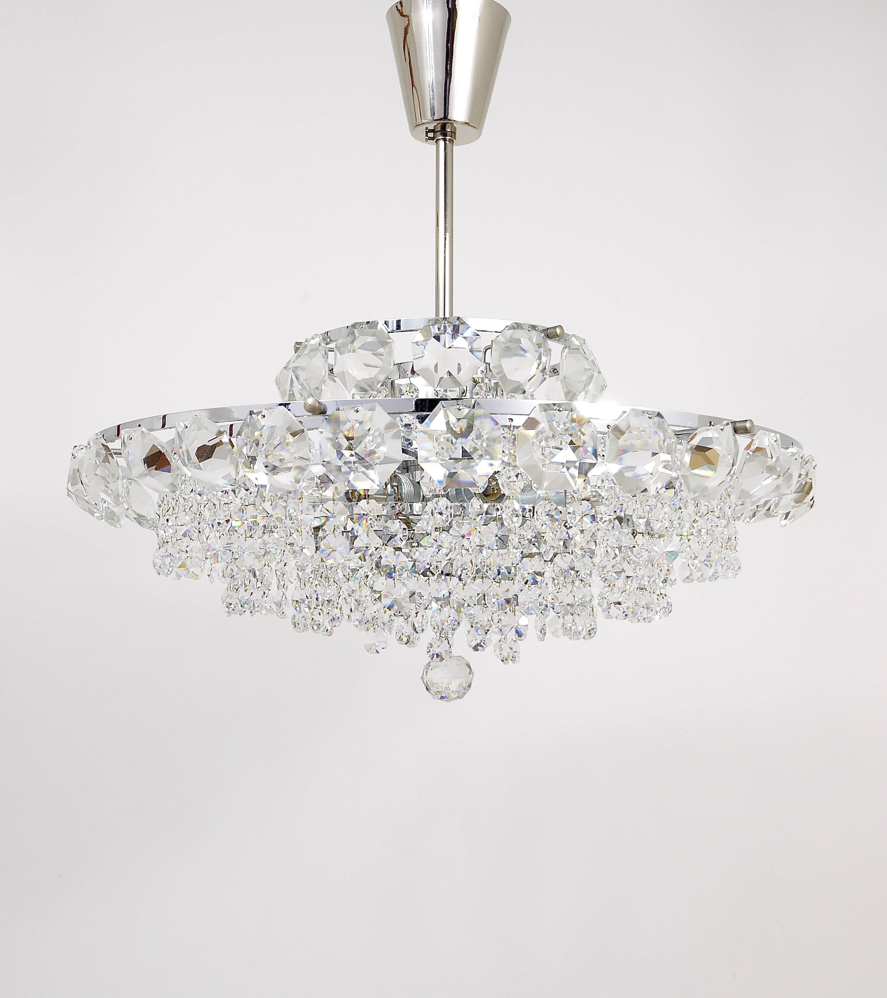A beautiful and elegant chrome-plated crystal chandelier by Bakalowits Vienna from the 1950s. It has five tiers, fully covered by diamond-shaped faceted crystals in different sizes. This chandelier has six light sources and has been carefully