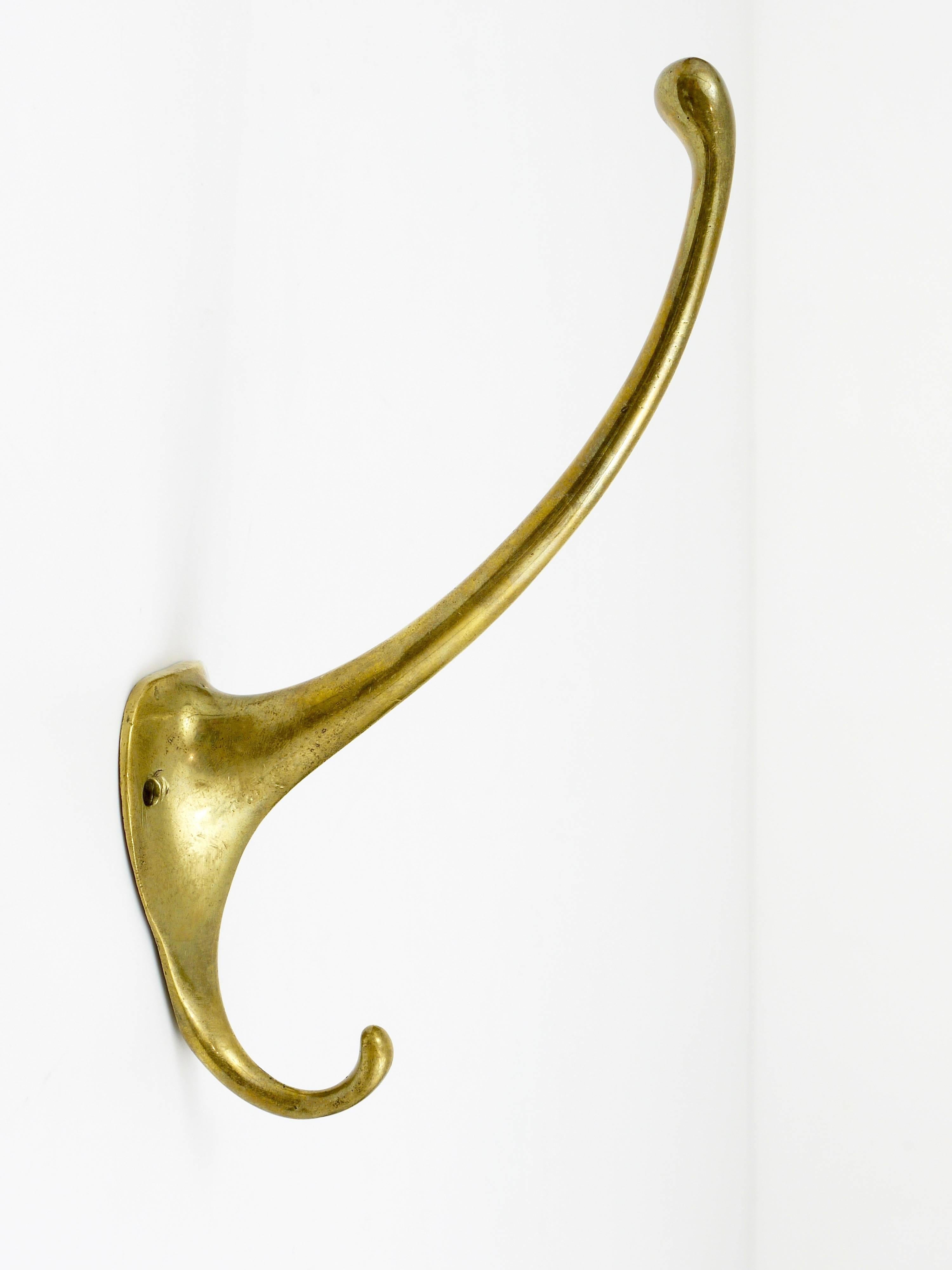 A beautiful Art Nouveau brass wall hook, designed by Adolf Loos, executed by Werkstaette Hagenauer, Vienna, 1910. In very good condition.