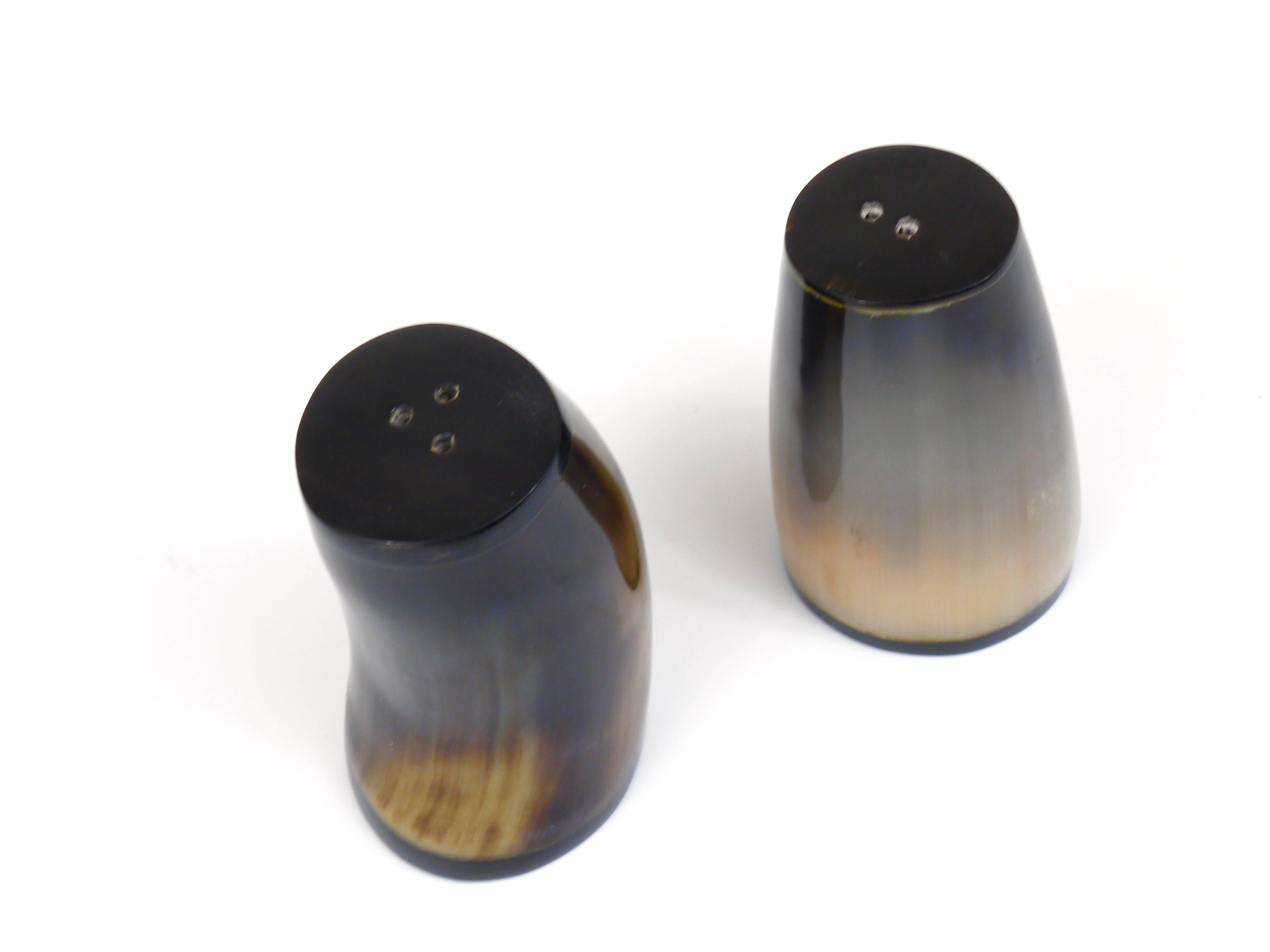 A pair of beautiful salt and pepper shakers, made of cow horn. Designed and executed by Carl Aubock, Vienna, Austria. In excellent condition.