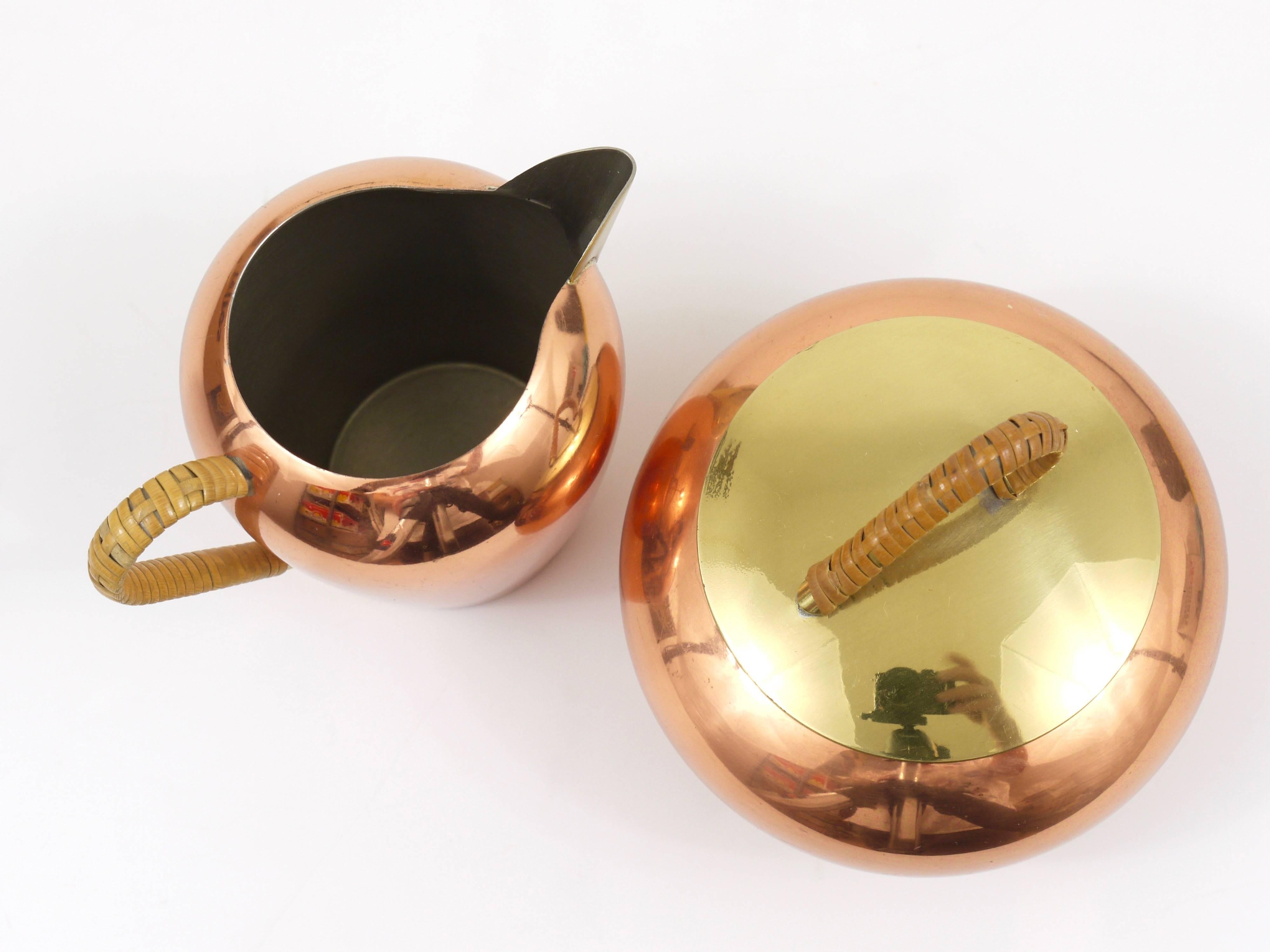 A beautiful set of a milk creamer and a sugar bowl, made of copper and brass with nice wicker handles. Executed in the 1950s by Erich Kolbenheyer, Vienna Austria. In excellent condition. 