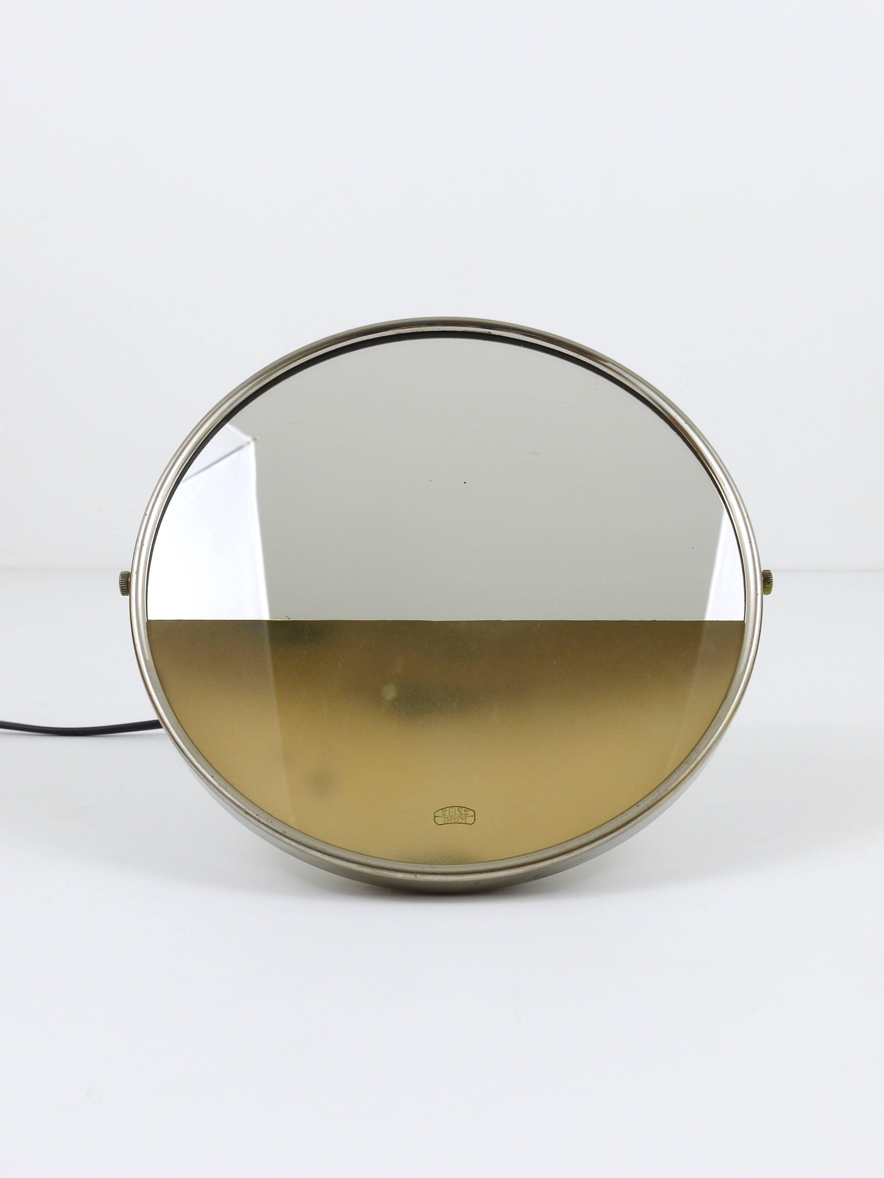 A beautiful illuminated Bauhaus vanity mirror, designed by Marcel Breuer in 1930, executed by Zeiss Ikon, Berlin, Germany. Made of nickel-plated metal and mirror. To be used on a table or wall-hanging. In good condition with nice patina.