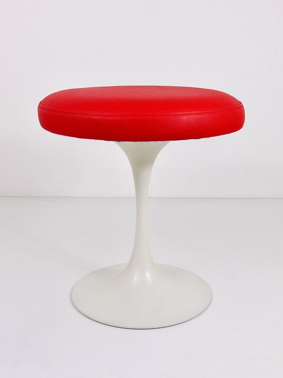 A beautiful stool with a white tulip base and red synthetic leather upholstery from the 1960s, designed by Maurice Burke for Arkana, United Kingdom. In the style of Eero Saarinen, Knoll. In excellent condition. Marked on its underneath.
