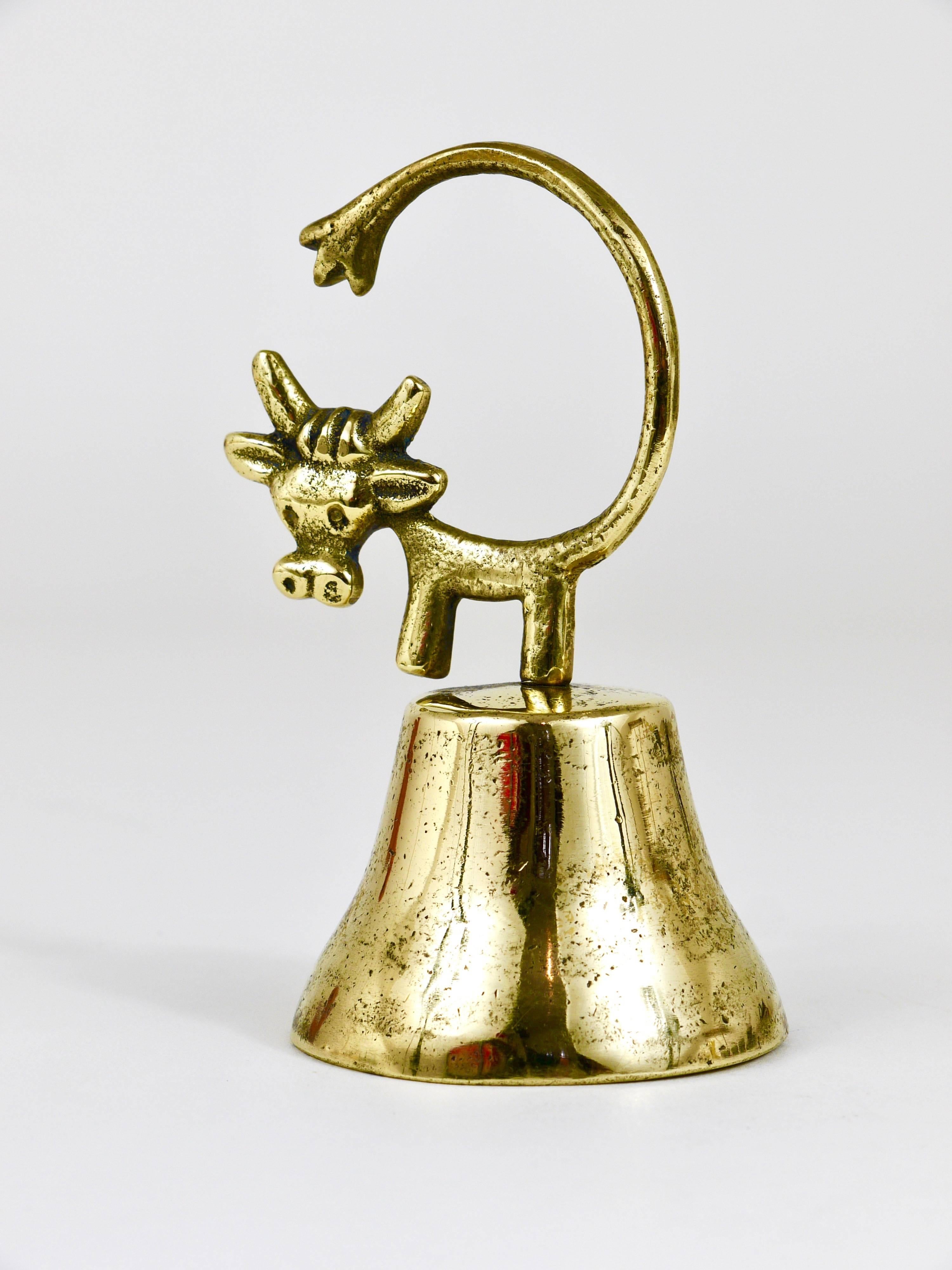 A charming Austrian table bell, displaying a cow. A very humorous design by Walter Bosse, executed by Hertha Baller Austria in the 1950s. Made of brass, in good condition with nice patina.
