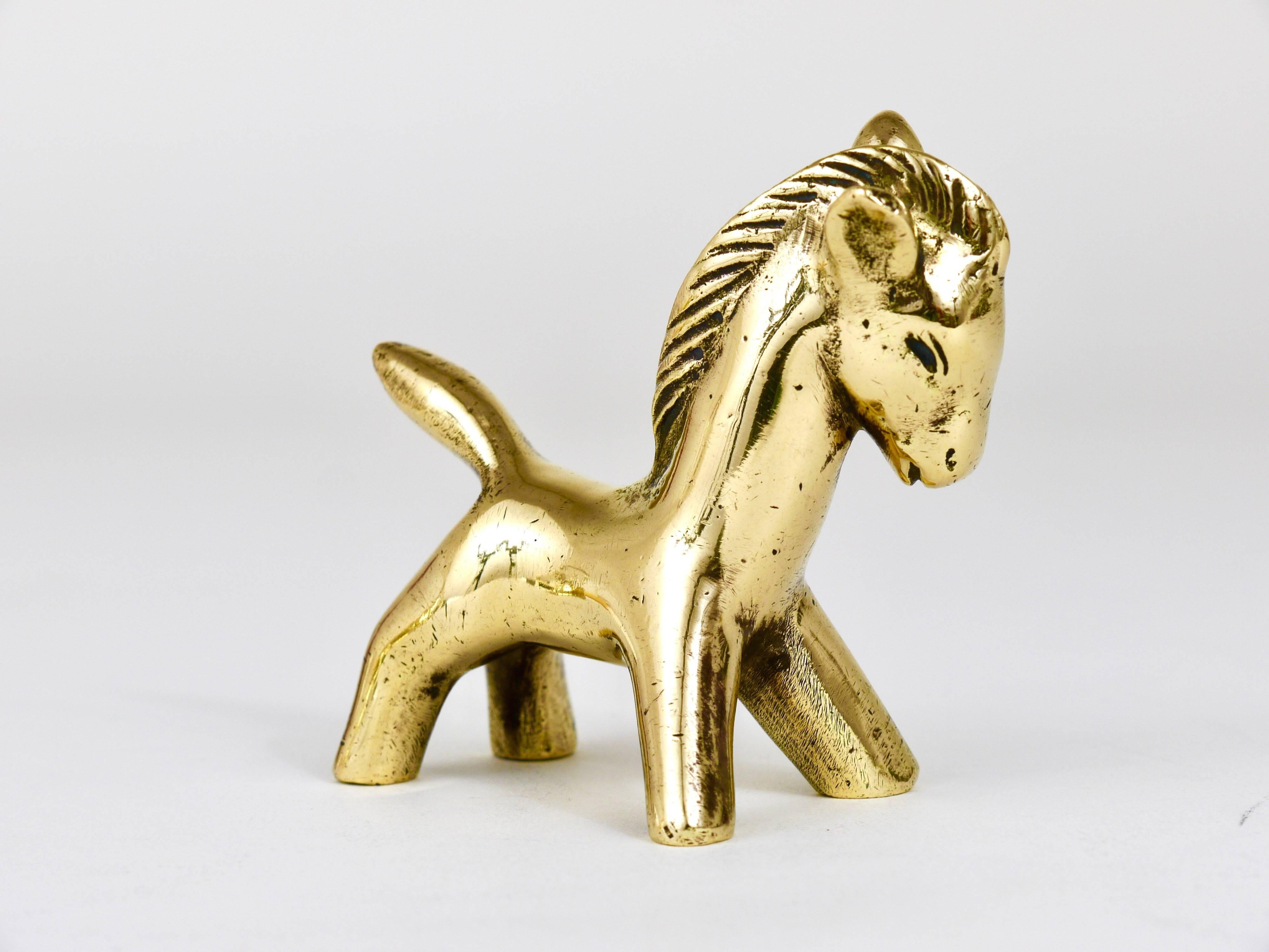 A lovely horse foal sculpture made of brass from the 1950s. Designed by Walter Bosse, executed by Hertha Baller. In good condition with charming patina. We offer more Walter Bosse brass objects in our other listings.