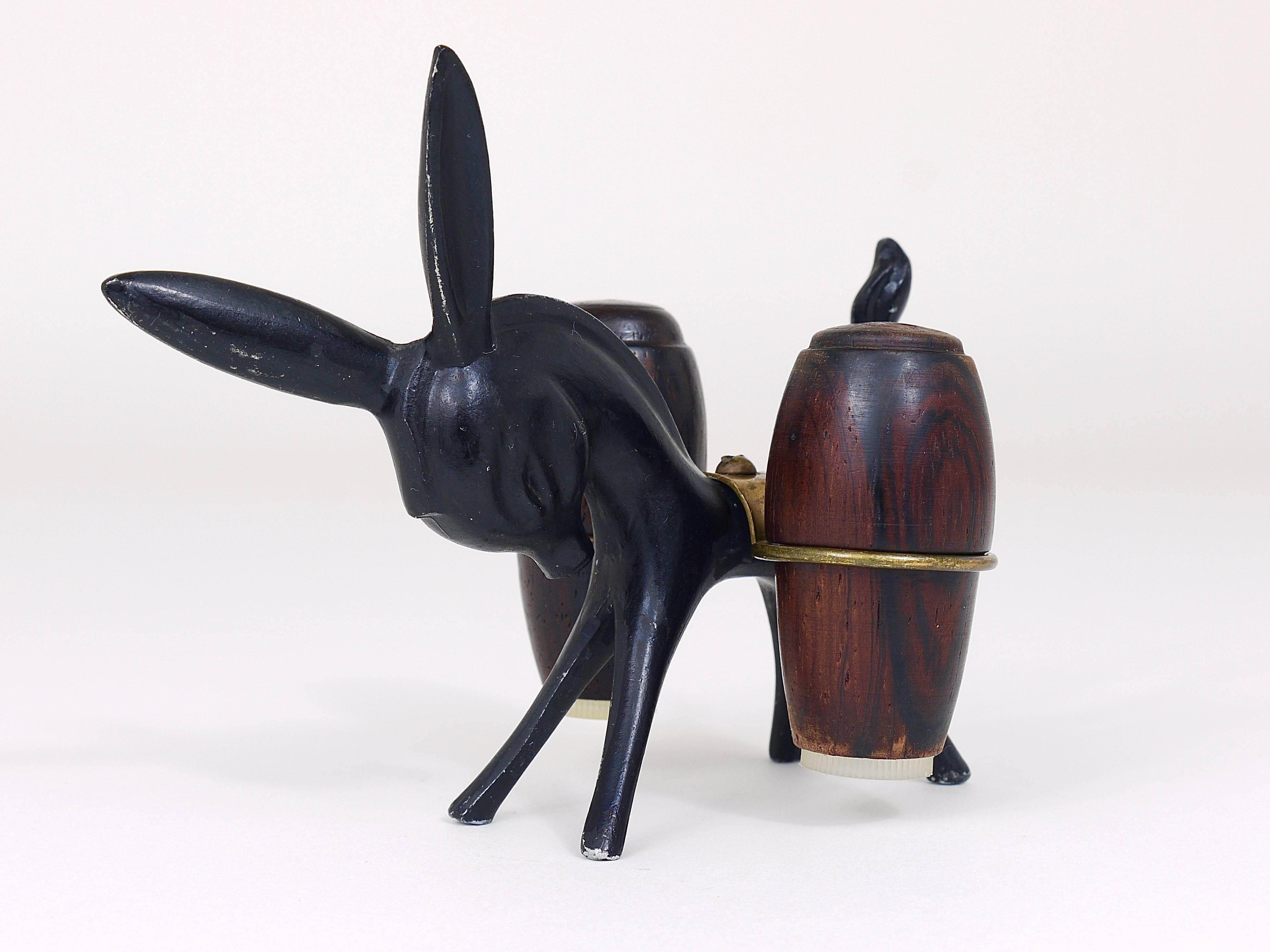 A charming Austrian midcentury shaker set, displaying a donkey. A very humorous design by Walter Bosse, executed by Hertha Baller Austria in the 1950s. Made of metal and walnut wood. In very good condition with marginal patina.