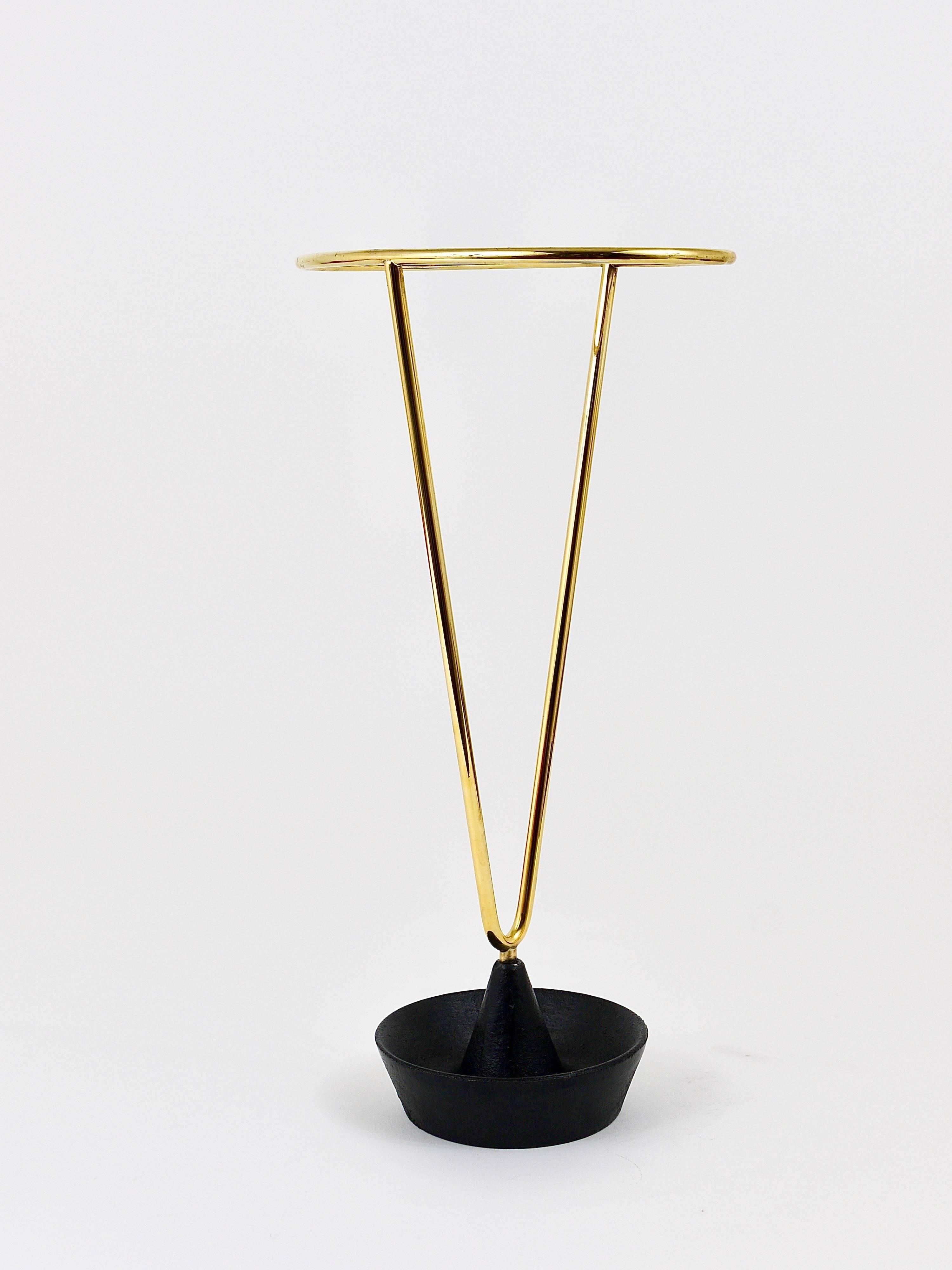 A straight and beautiful Austrian umbrella stand, made of brass and cast iron. Designed and executed by Carl Auböck. A sophisticated piece, one of the most beautiful umbrella stands we know. In excellent condition. Marked.