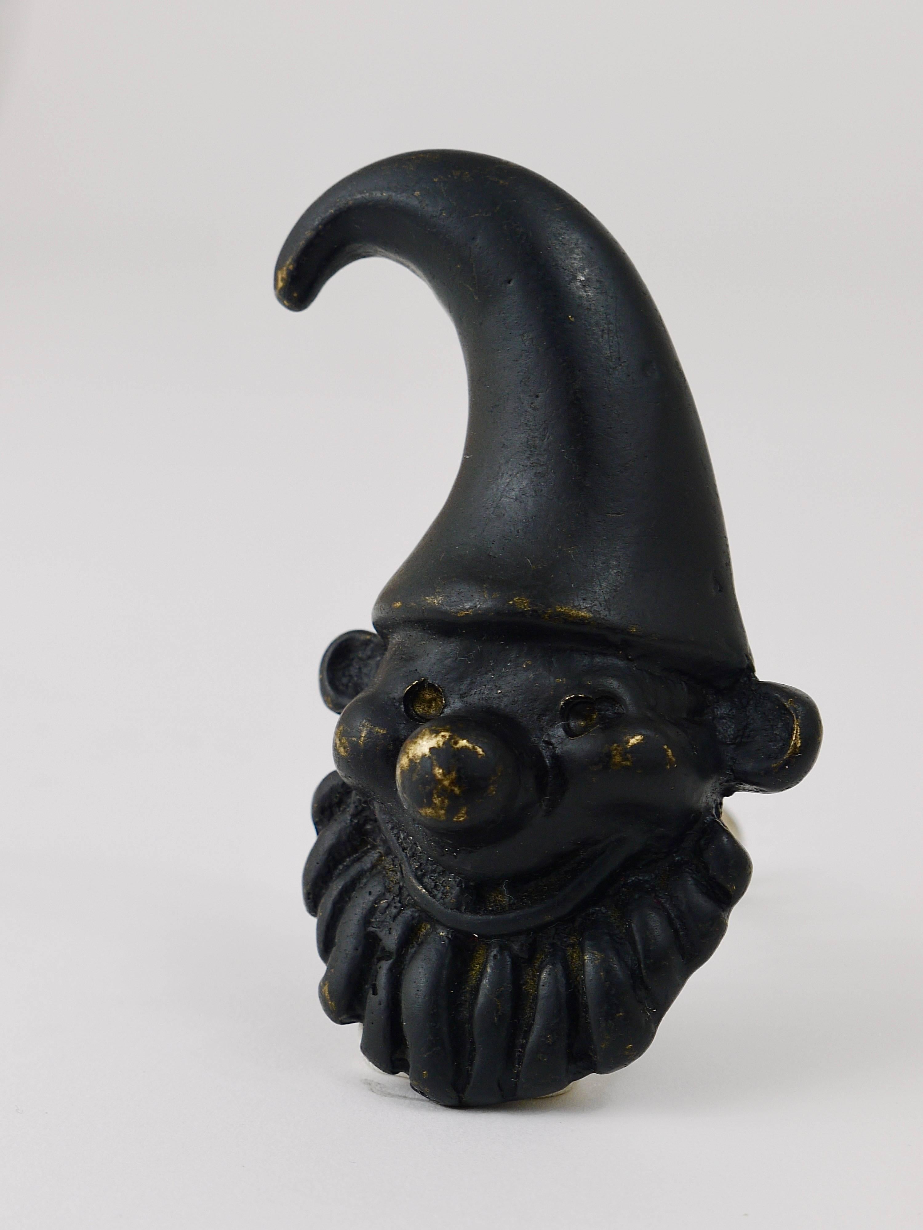 A charming Mid-Century bottle opener/cork screw, displaying a dwarf. A humorous design by Walter Bosse, executed by Hertha Baller Austria in the 1950s. Made of black-finished brass, in good condition.