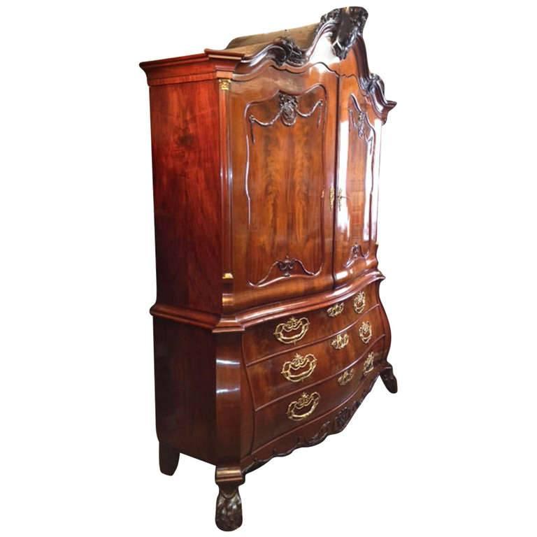 The serpentine and bombe profile from both the doors as well as the drawers proclaim the high quality of this piece.
The cornice, Louis Seize in form, provides for a garniture of vases. Other features include the carved head of King Louis Seize in